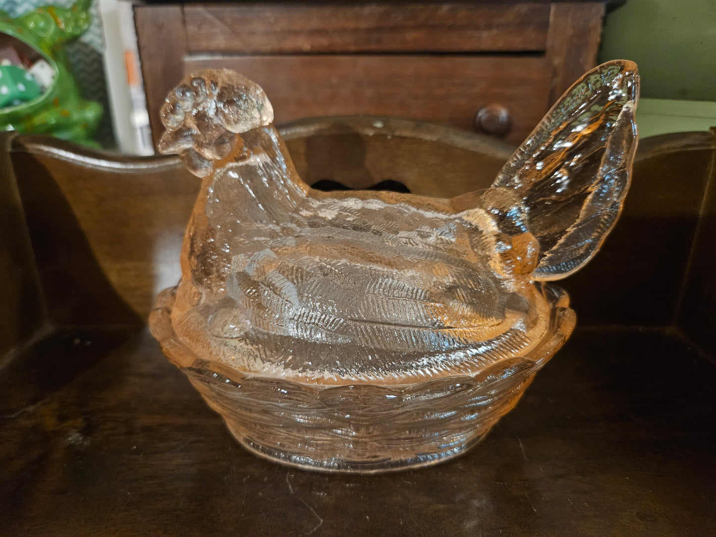 Modern clear pressed glass hen on a nest covered dish 5 inch showing detailed feather texture and basket weave base in natural light