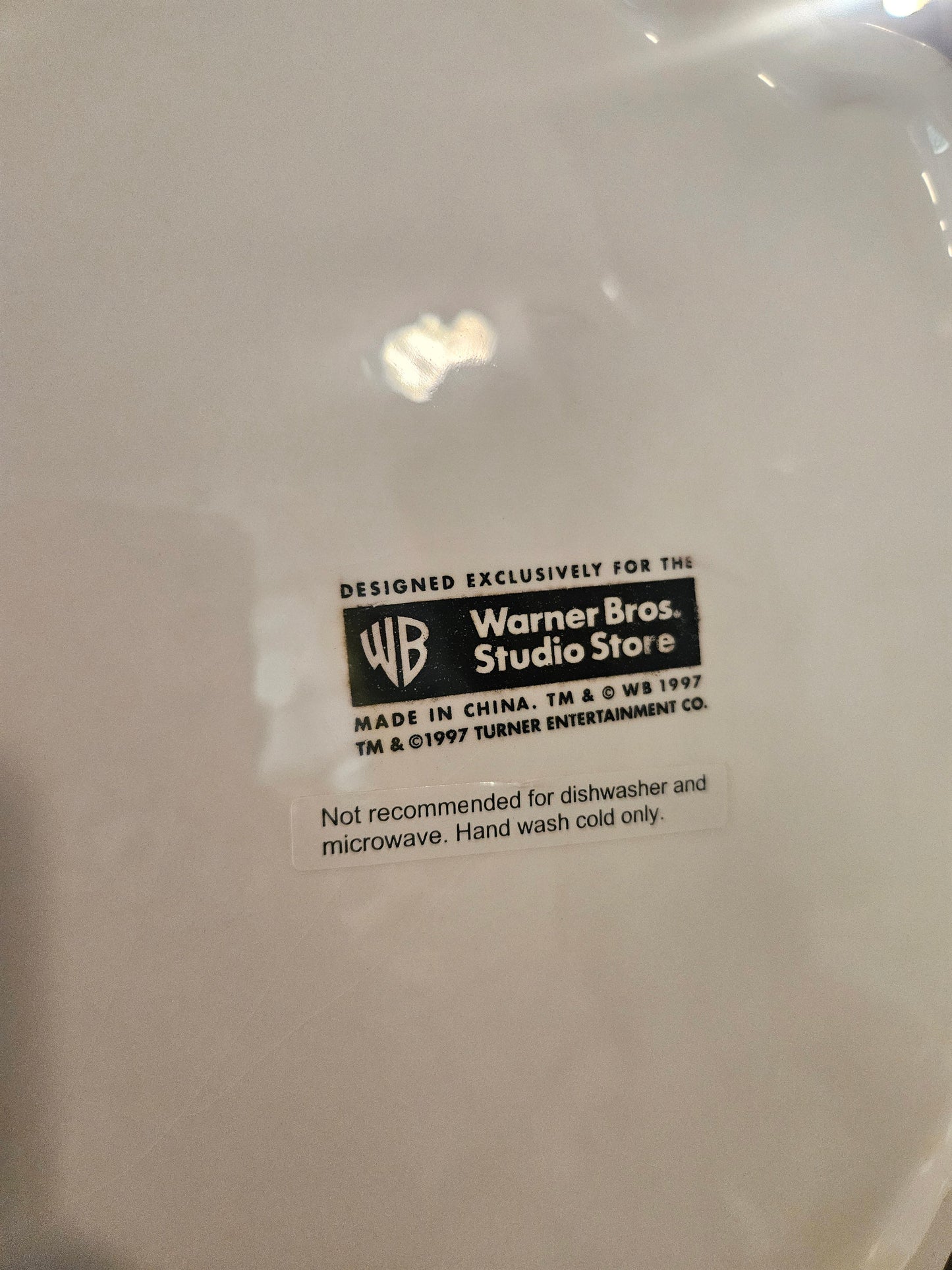 Bottom of Glinda cookie jar showing Warner Bros Studio Store 1997 Turner Entertainment license mark and care instructions