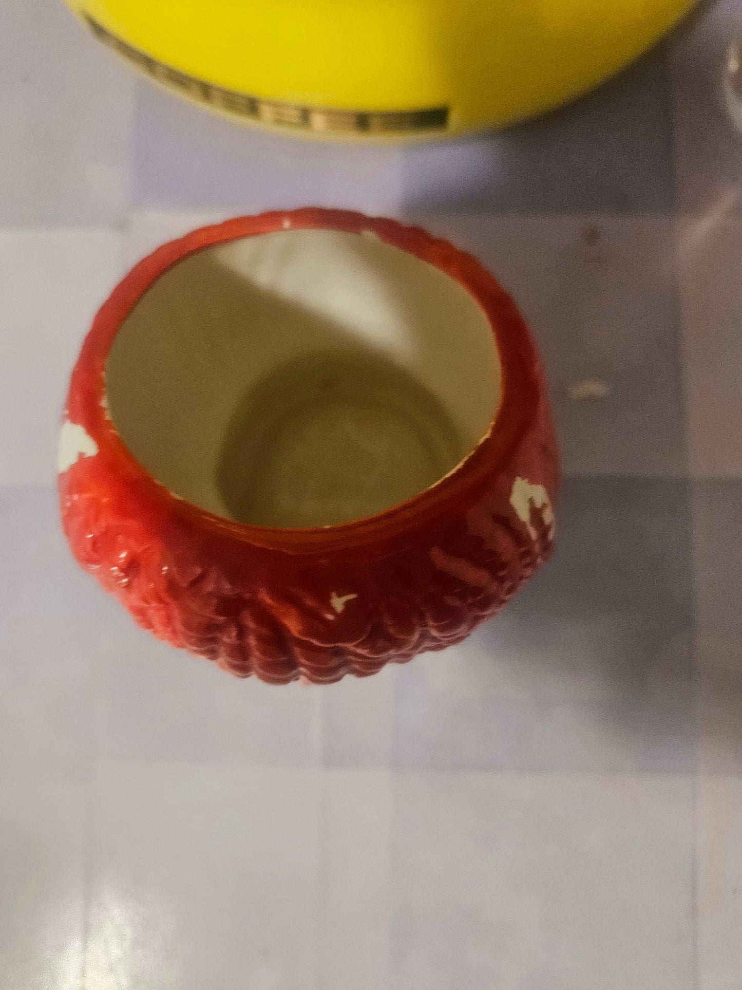 Vintage Raggedy Ann ceramic planter top down view showing paint loss detail
