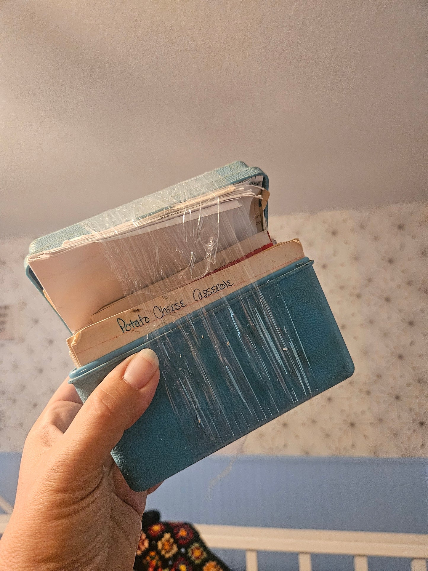 Vintage teal blue recipe box held open showing recipe cards inside