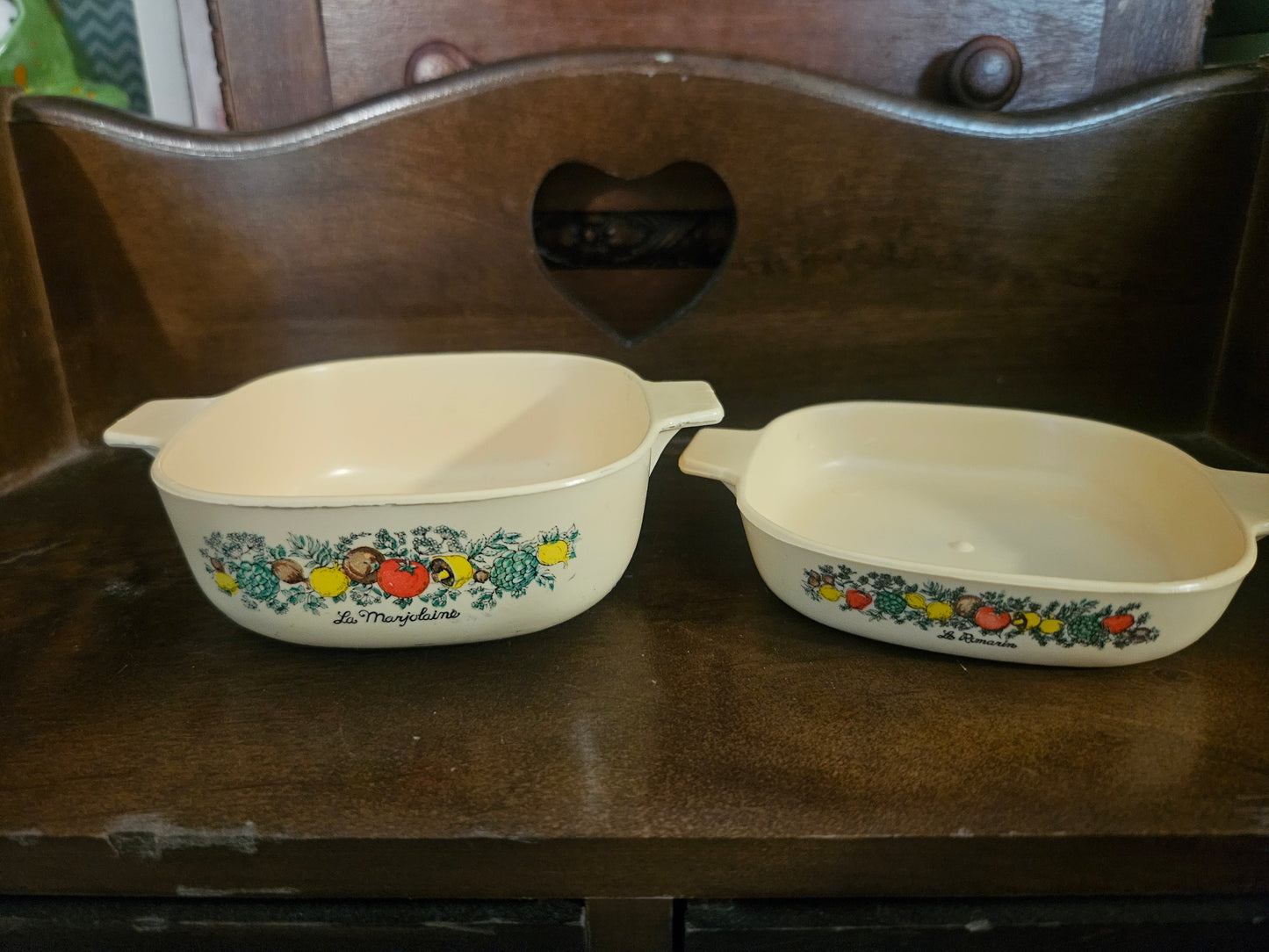 Two vintage plastic toy Corning Ware Spice of Life casserole dishes — La Marjolaine (larger) and La Romarin (smaller)