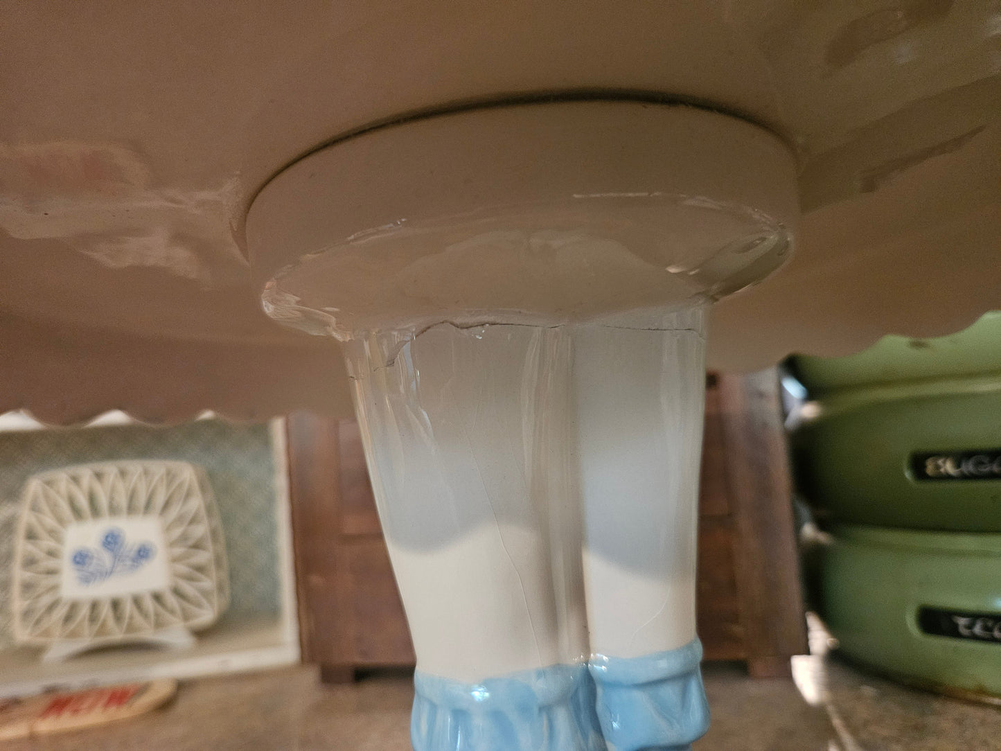 Underside of Dorothy cake stand showing crack where pedestal meets plate rim