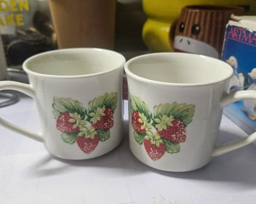 Pair of Gibson strawberry mugs with red strawberry and green leaf motif