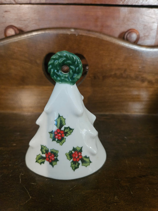 Vintage white ceramic Christmas tree bell with holly berry motif and green sculpted wreath handle, approximately 3 inches tall