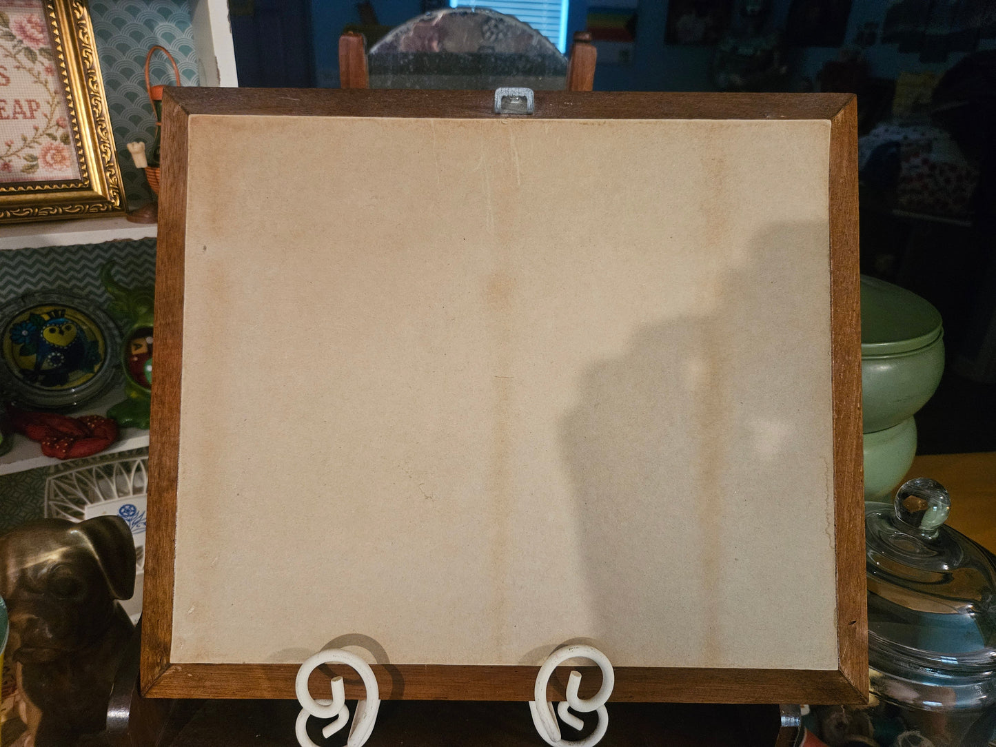 Back of framed duck print showing sawtooth hanger and plain backing board