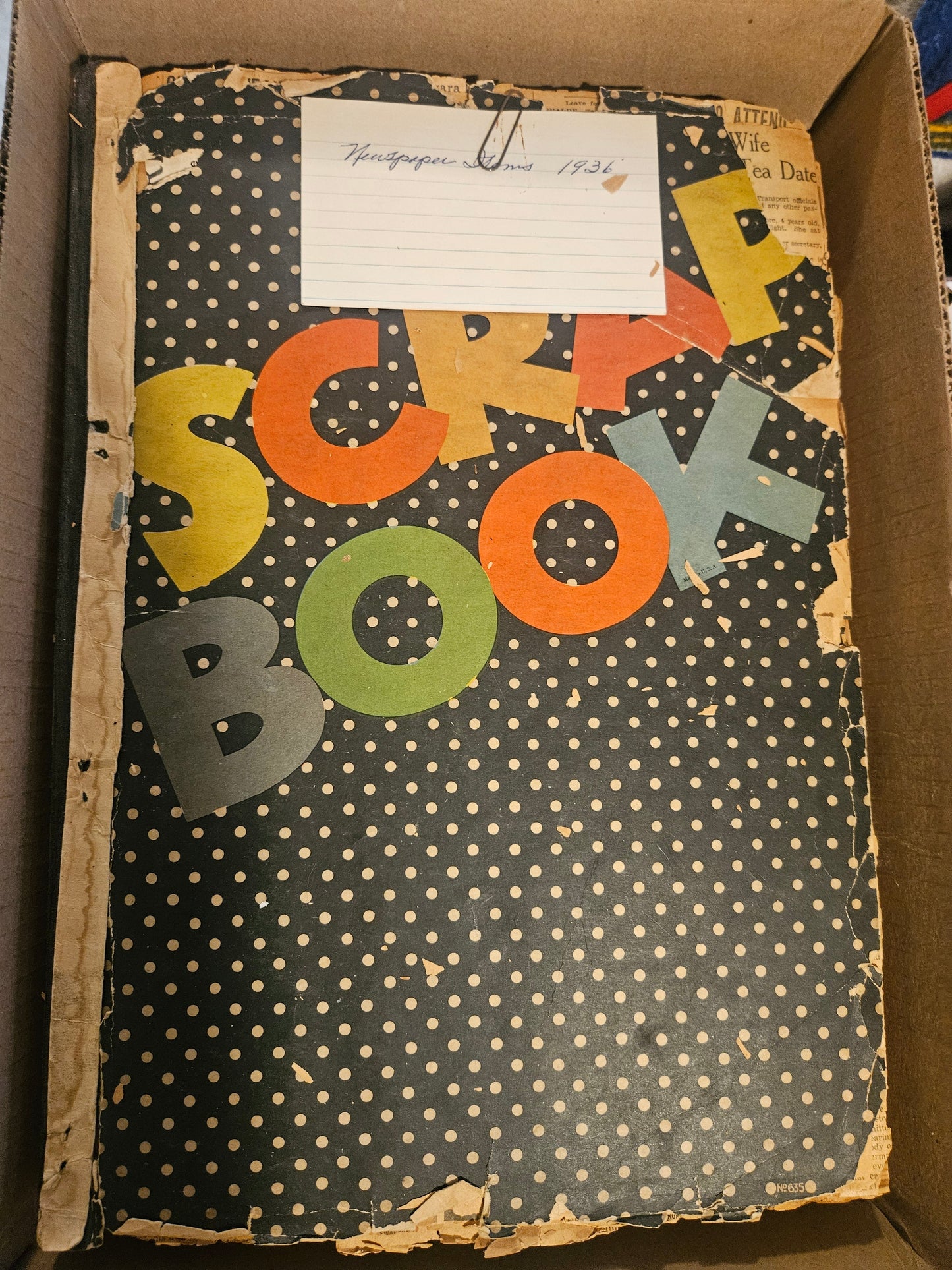 Black polka-dot Scrap Book cover with handwritten Newspaper Items 1936 index card