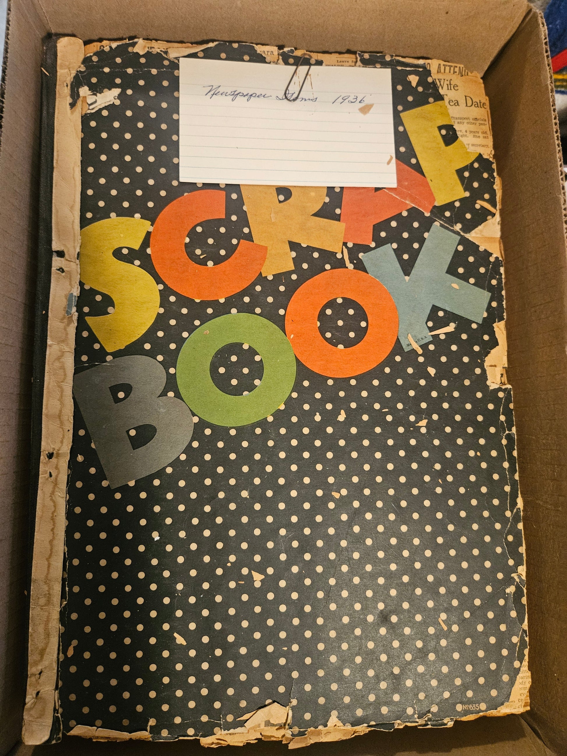 Black polka-dot Scrap Book cover with handwritten Newspaper Items 1936 index card