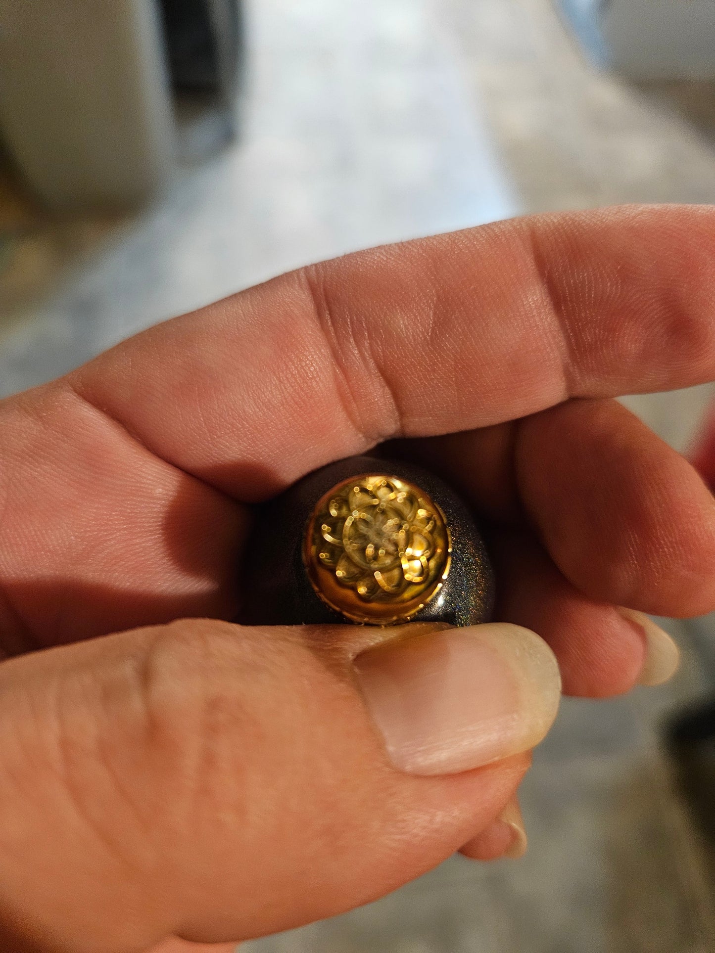 Top view of ornate gold filigree cap on Lampe Berger galaxy glitter miniature bottle