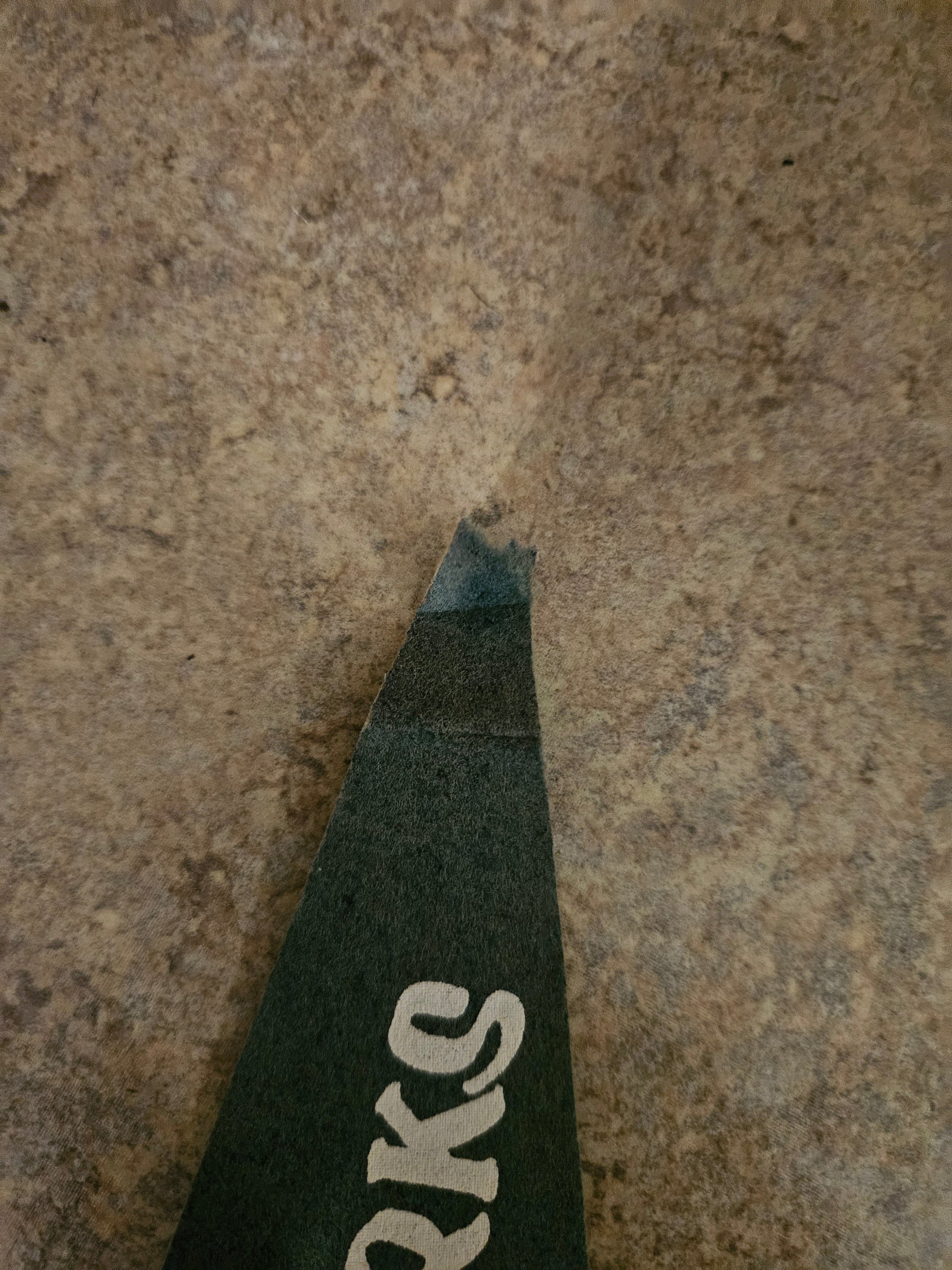 Close-up of missing frayed tip on vintage Ozarks felt pennant