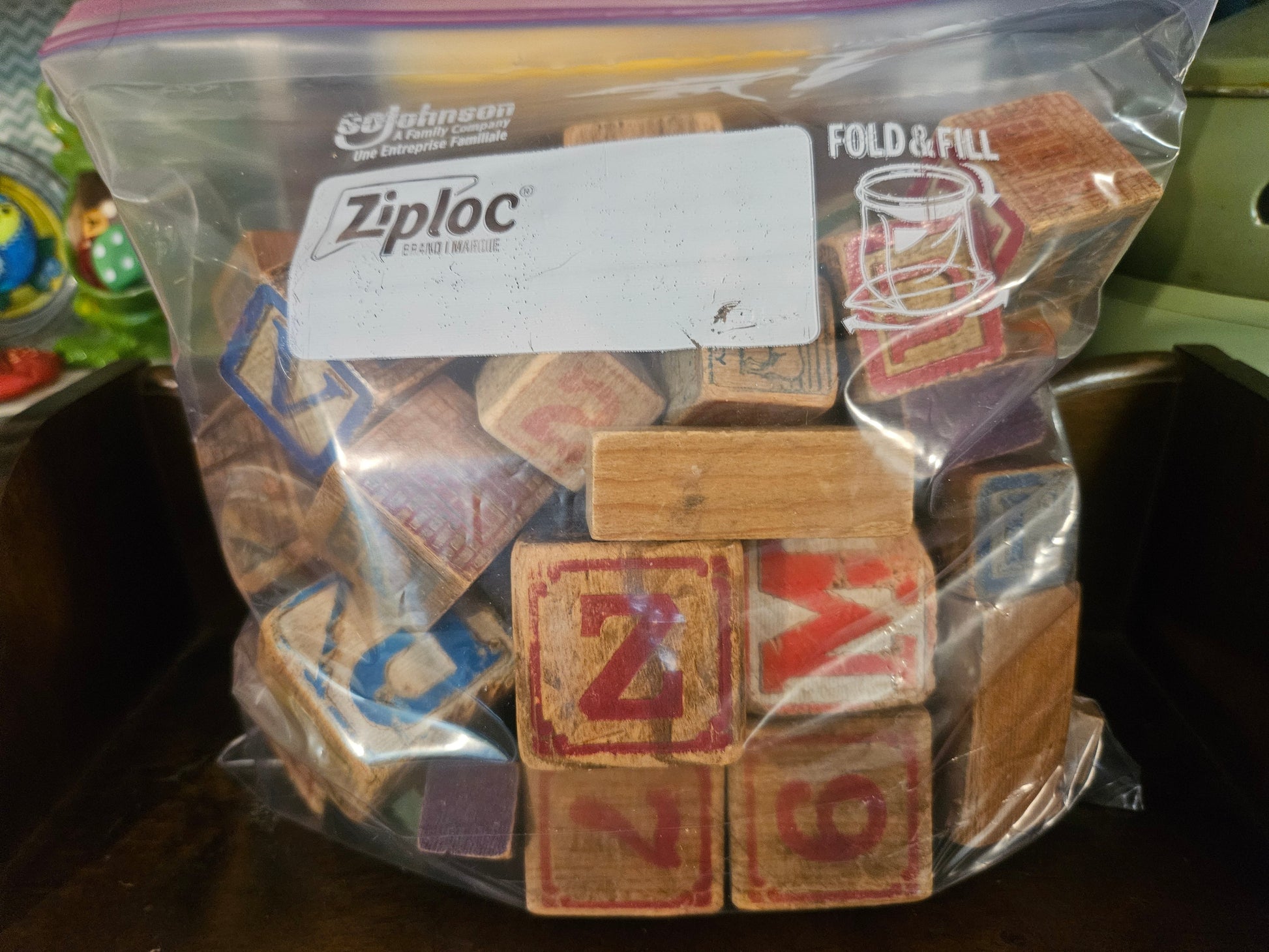 Back view of gallon Ziploc bag showing more vintage wooden blocks with letters and numbers