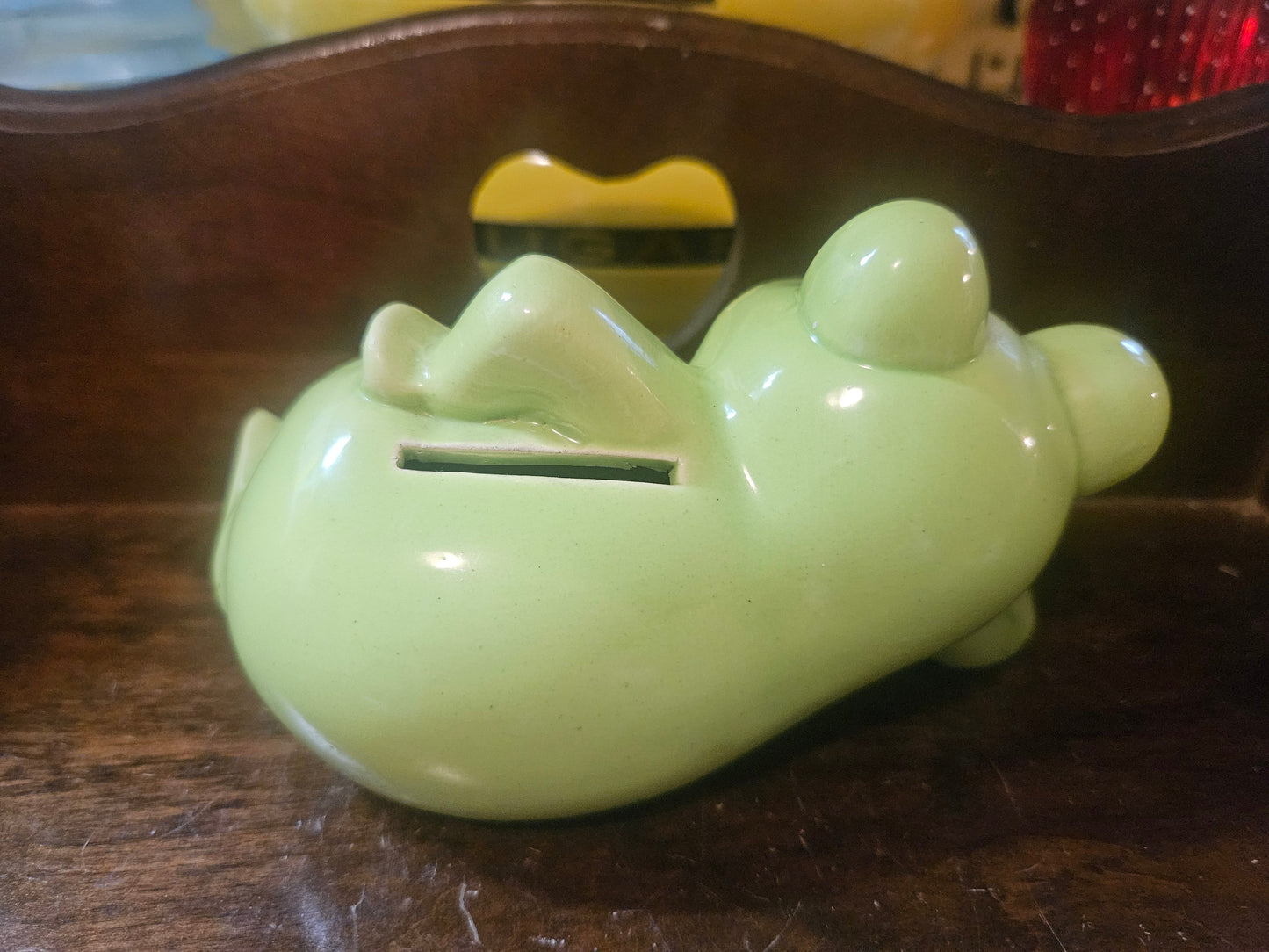 Side/back view showing coin slot on belly