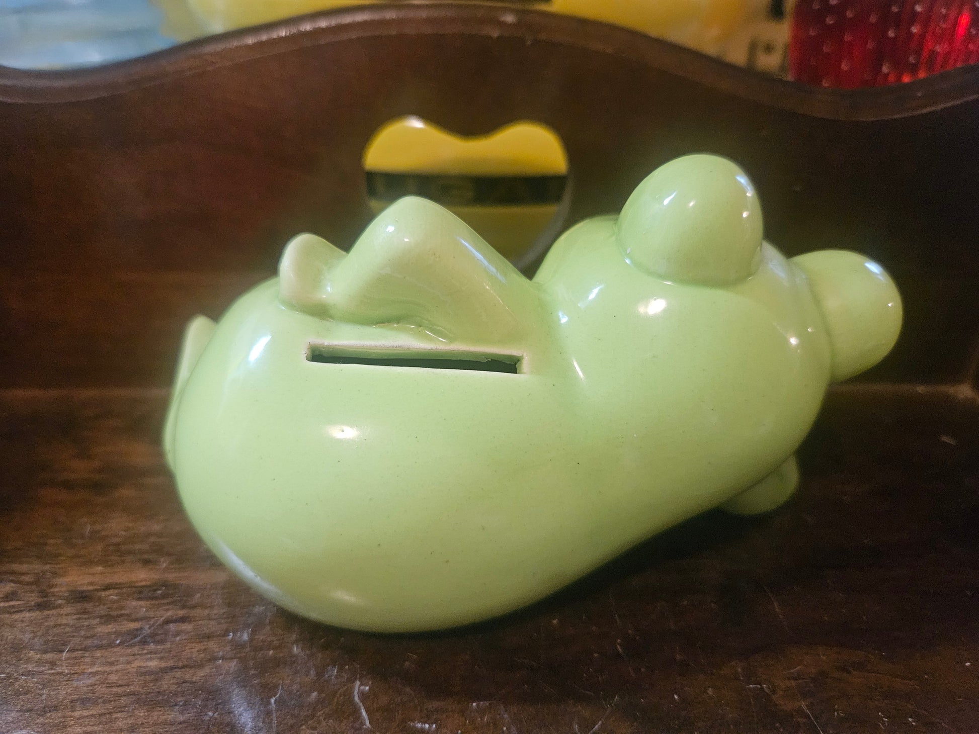 Side/back view showing coin slot on belly