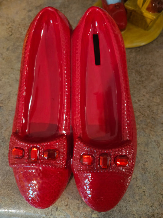 Wizard of Oz Ruby Slippers ceramic coin bank by Westland Giftware showing glossy red glaze and red rhinestone jewel toe accents