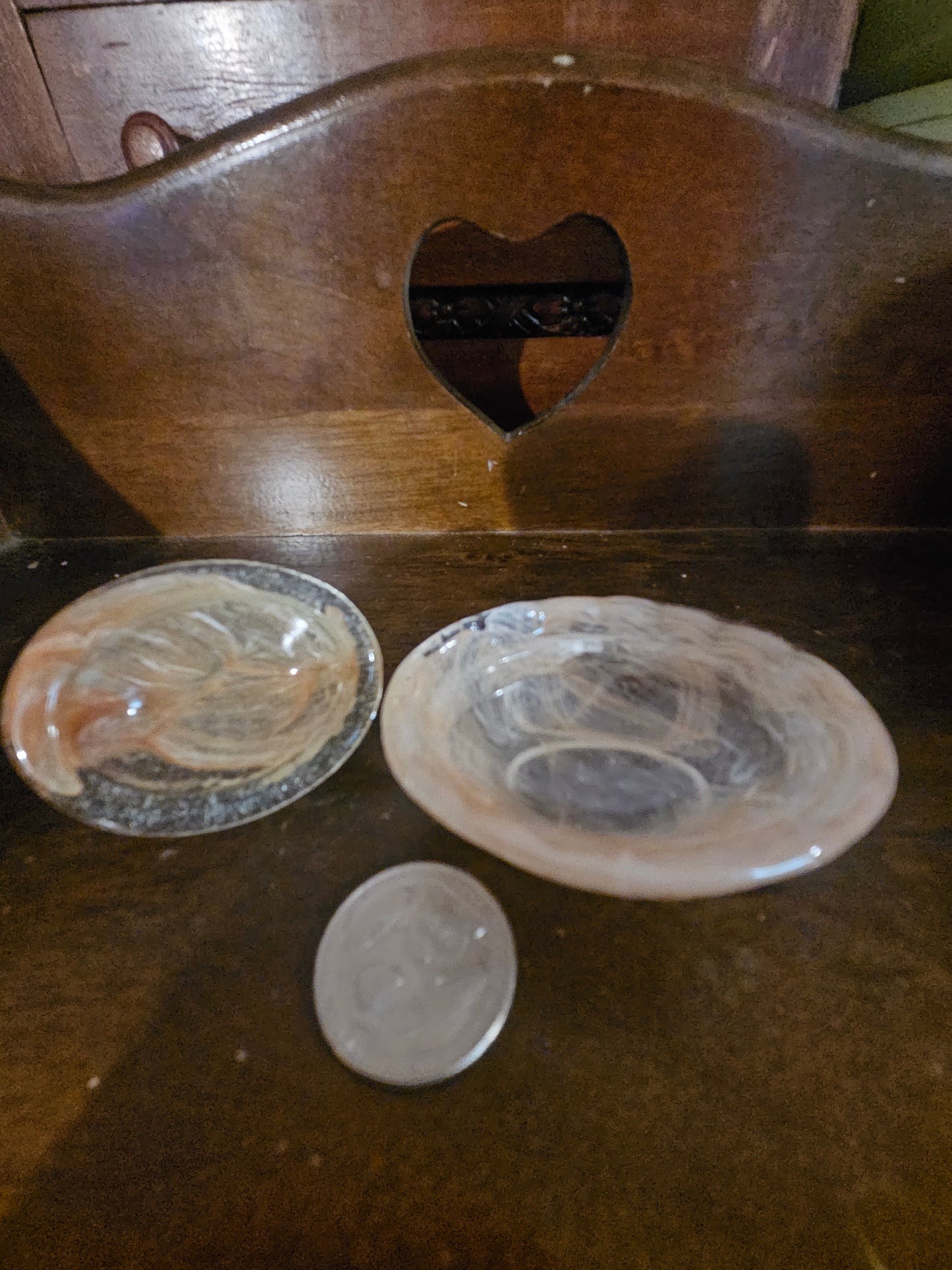 Pink opalescent glass hen on nest separated into three pieces showing hen lid nest base and small round glass egg insert