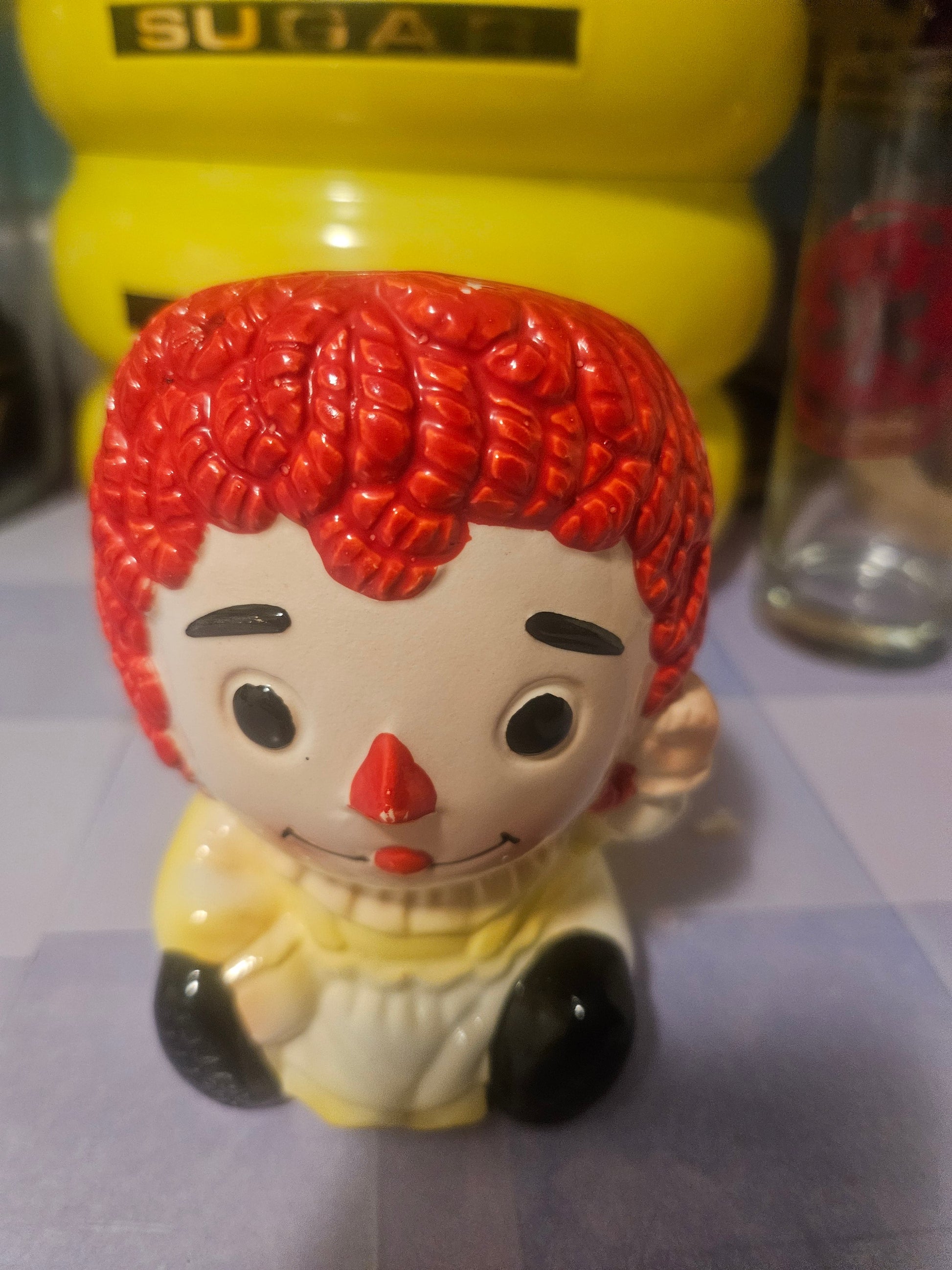 Vintage Raggedy Ann ceramic planter front view showing painted face with button eyes and rosy cheeks