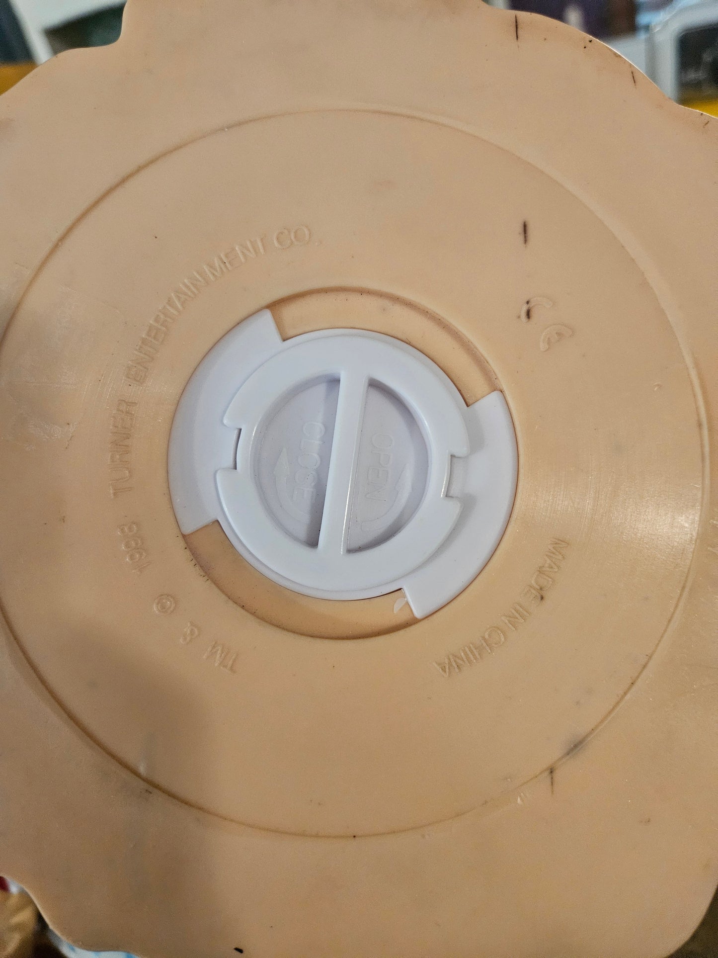 Bottom of Glinda coin bank showing removable plug for coin retrieval and Warner Bros 1998 Turner Entertainment license mark