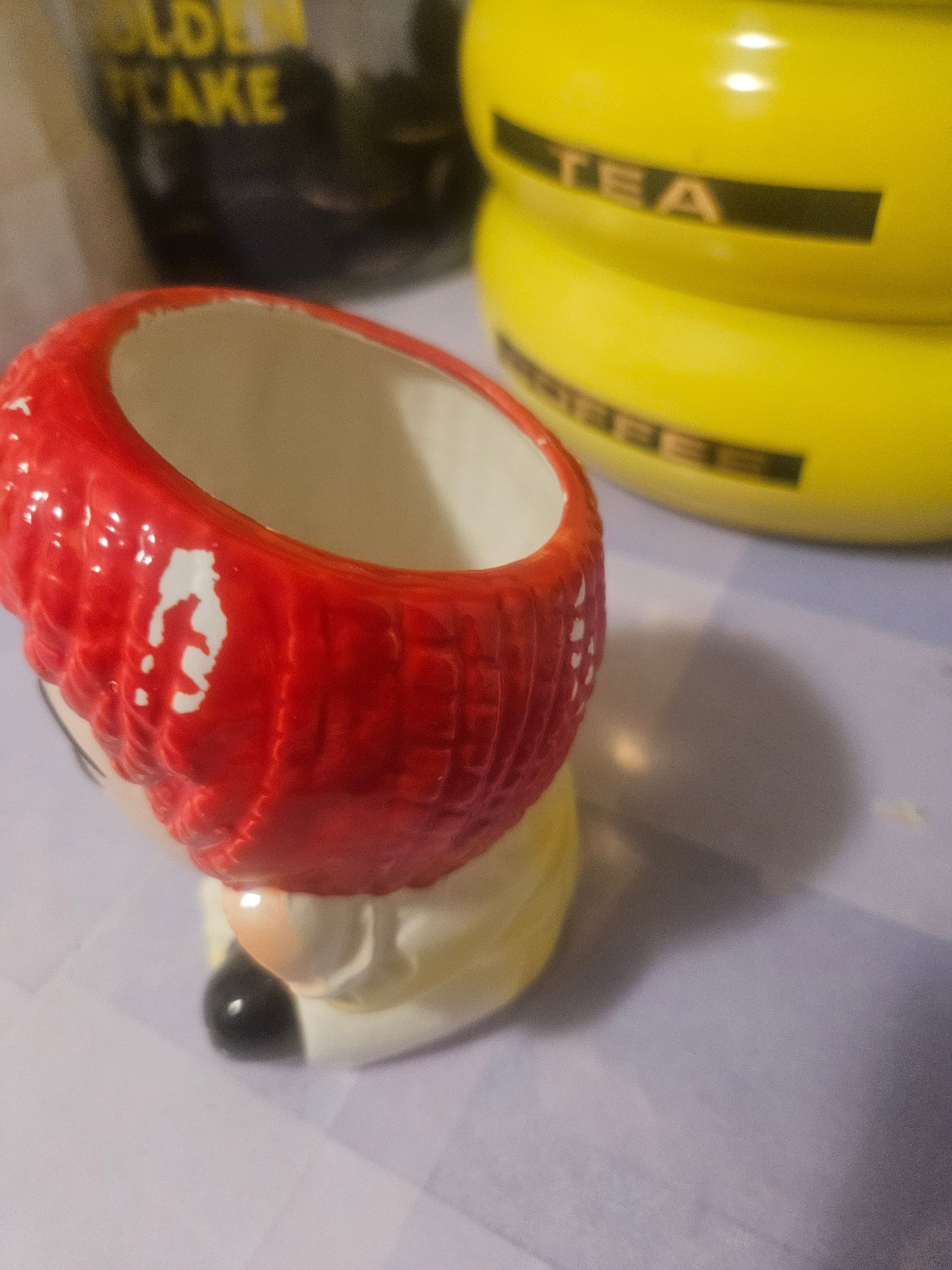 Vintage Raggedy Ann ceramic planter side view showing face and red hair