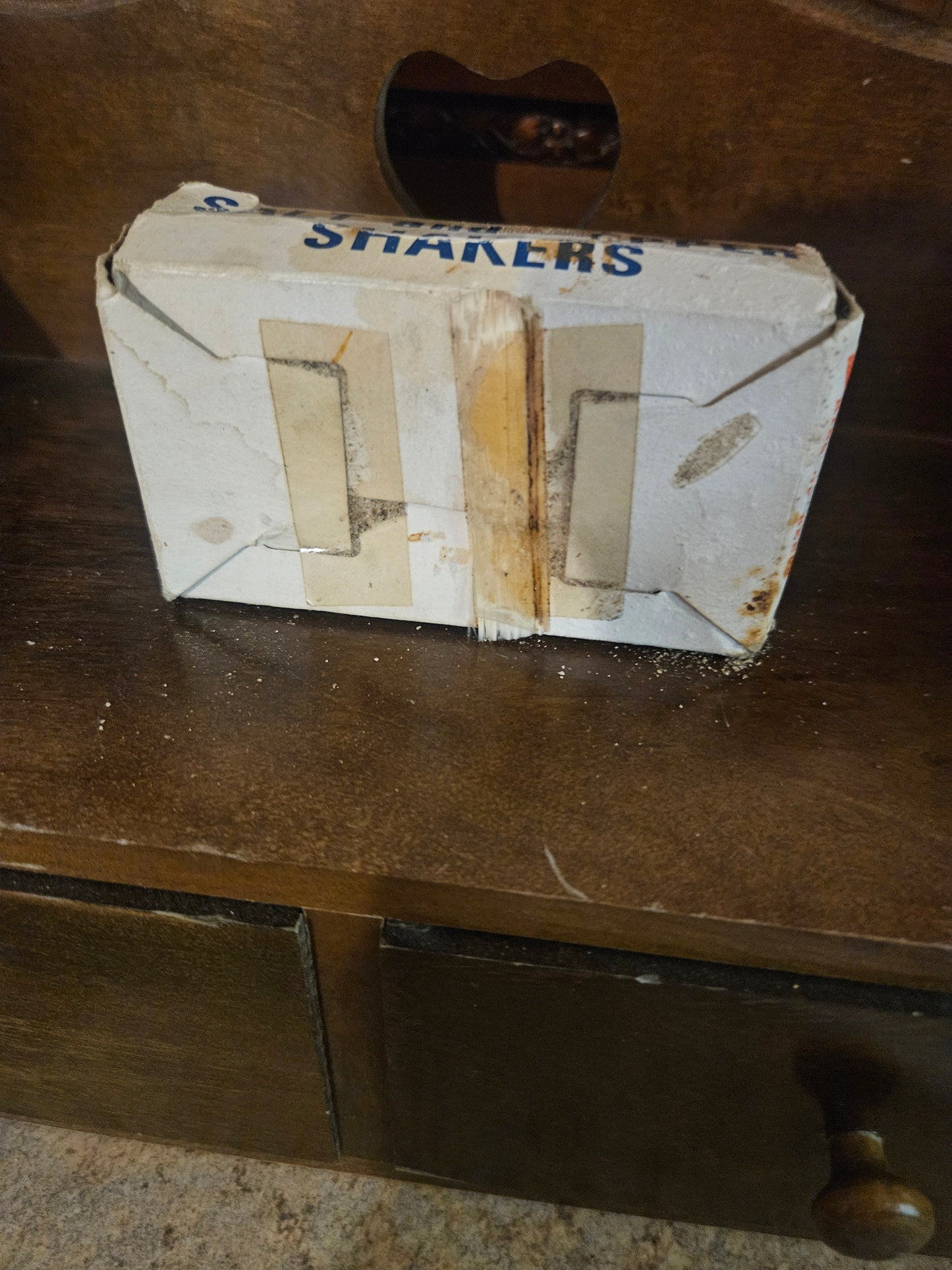 Original Budweiser salt and pepper shaker box back showing worn cardboard and bottle cutouts