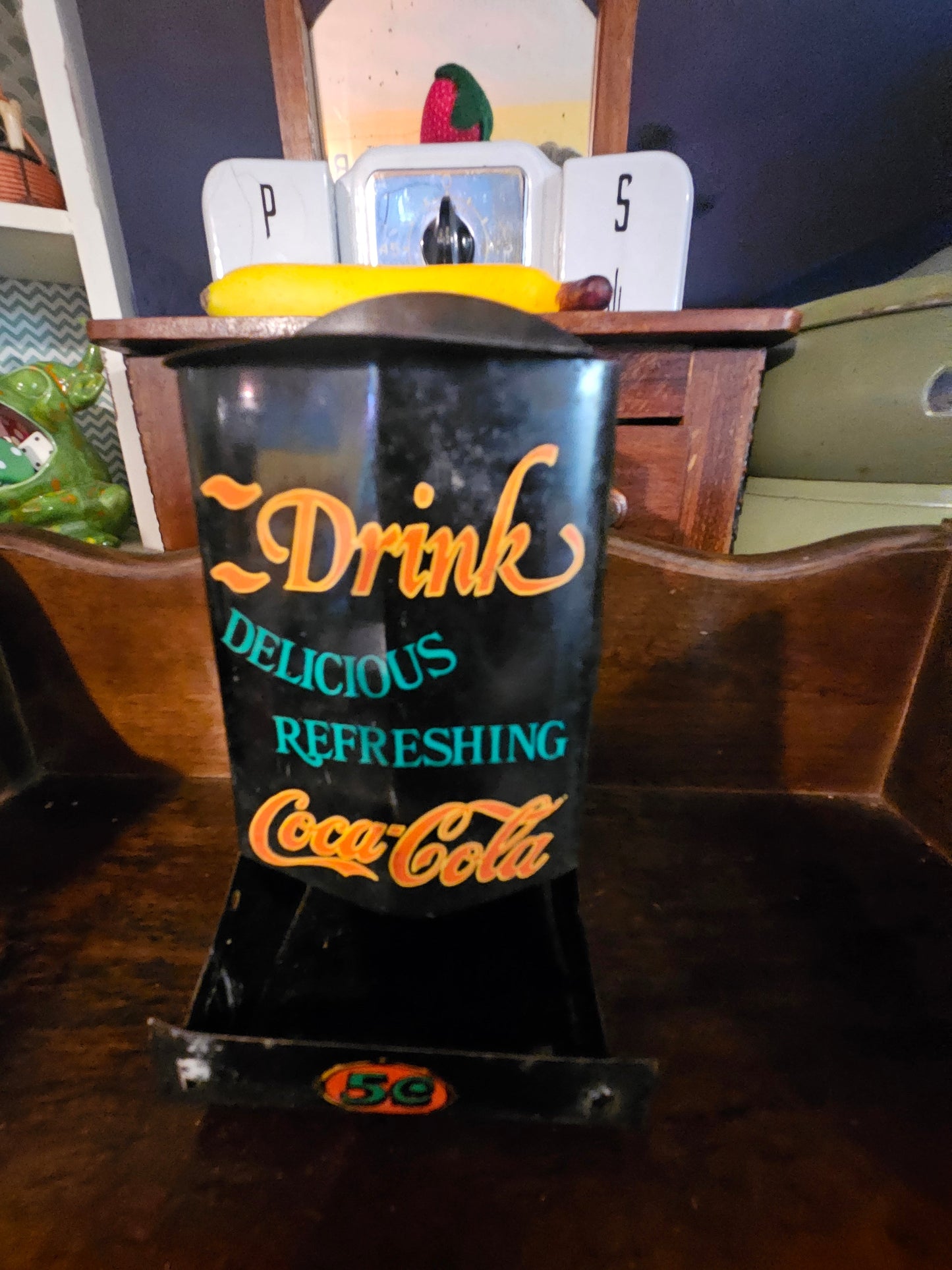 Vintage Coca-Cola countertop napkin holder front showing Drink Delicious Refreshing script and 5 cent badge