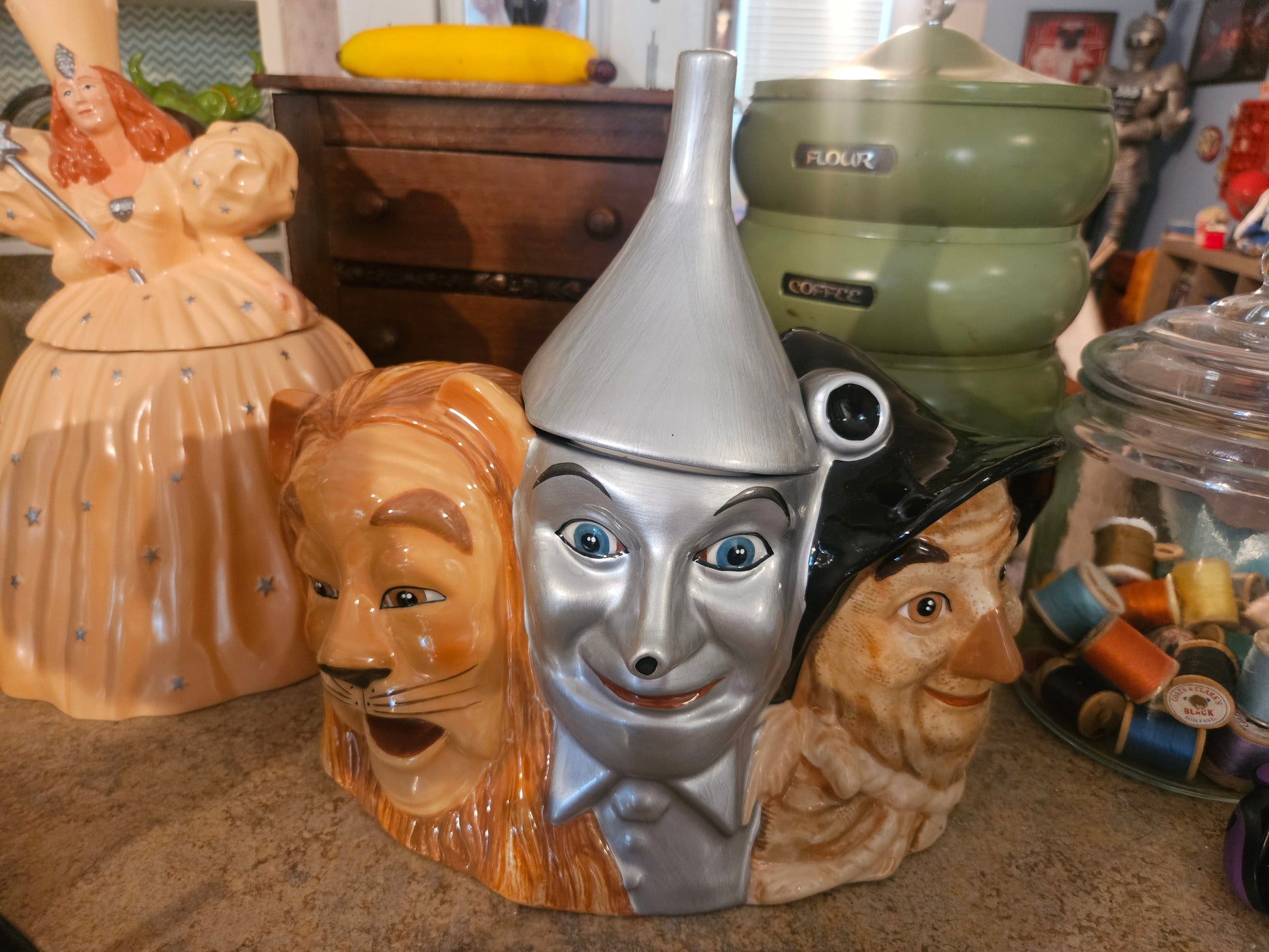 Wizard of Oz Scarecrow Tin Man and Cowardly Lion triple face ceramic cookie jar front view with Tin Man funnel hat lid