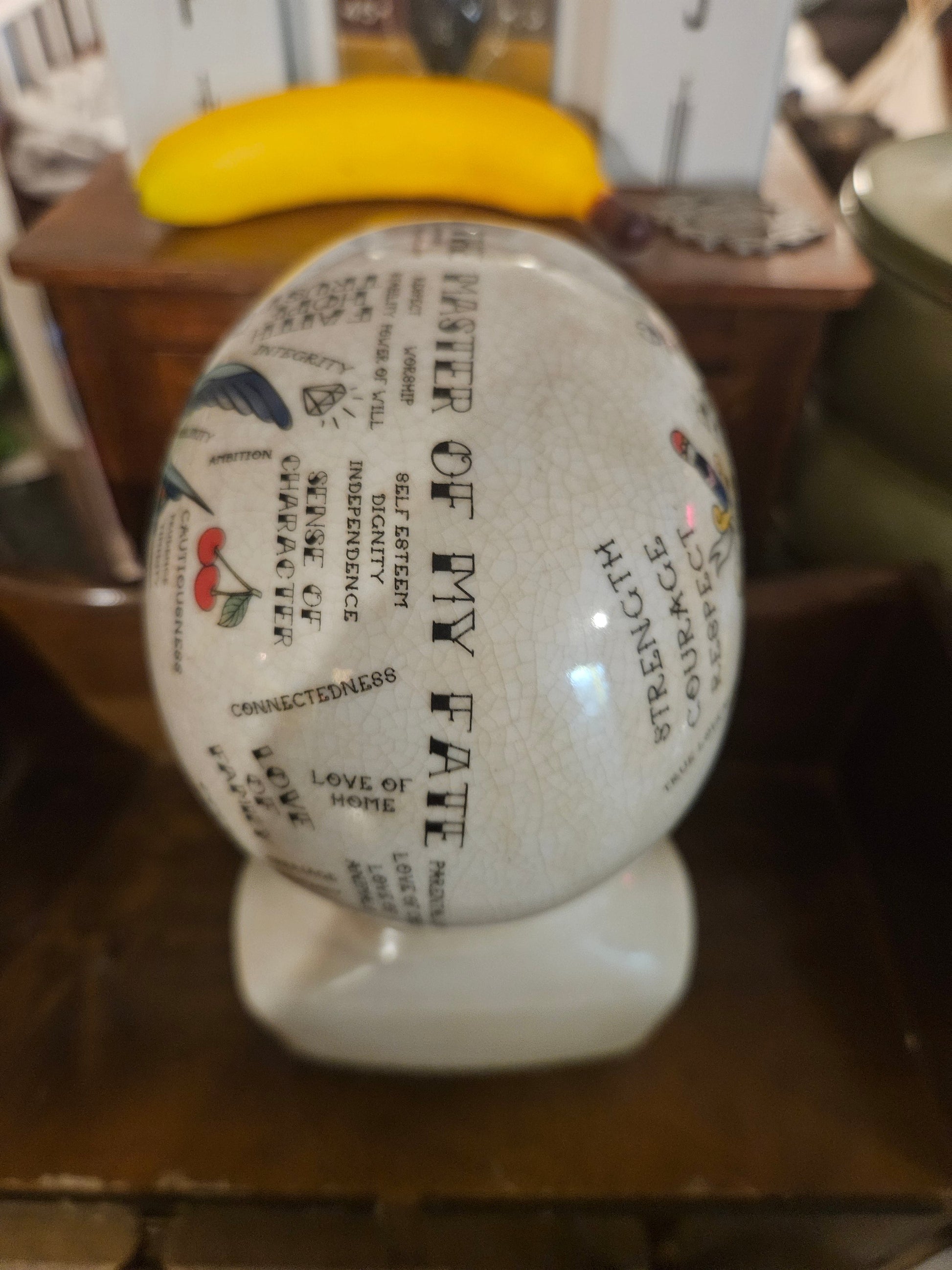 Top view of ceramic phrenology head planter showing Master of My Fate and phrenology map text
