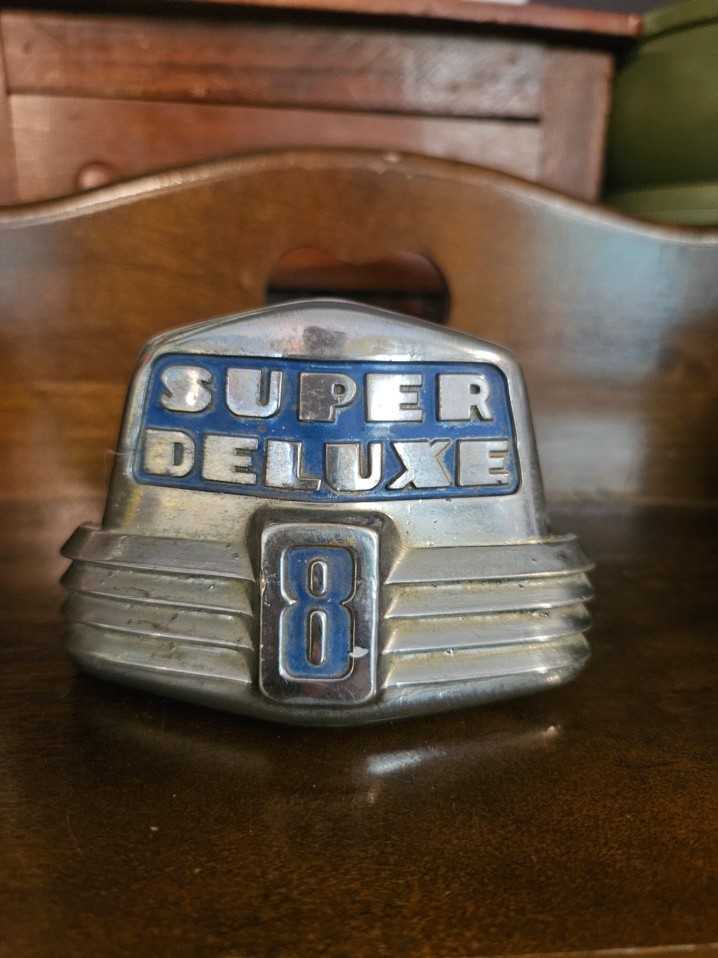 1946 Ford Super Deluxe 8 hood ornament emblem, front view showing chrome and blue enamel