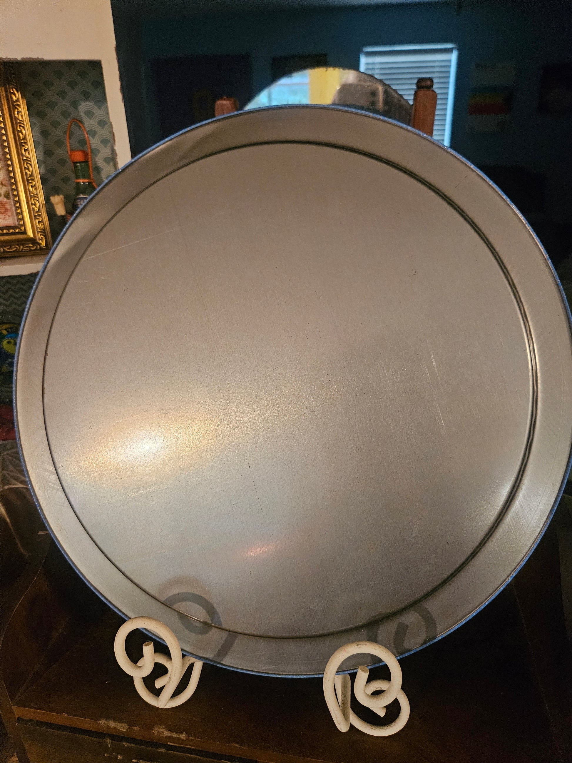 Back of vintage Giftco round metal tin tray showing plain metal reverse