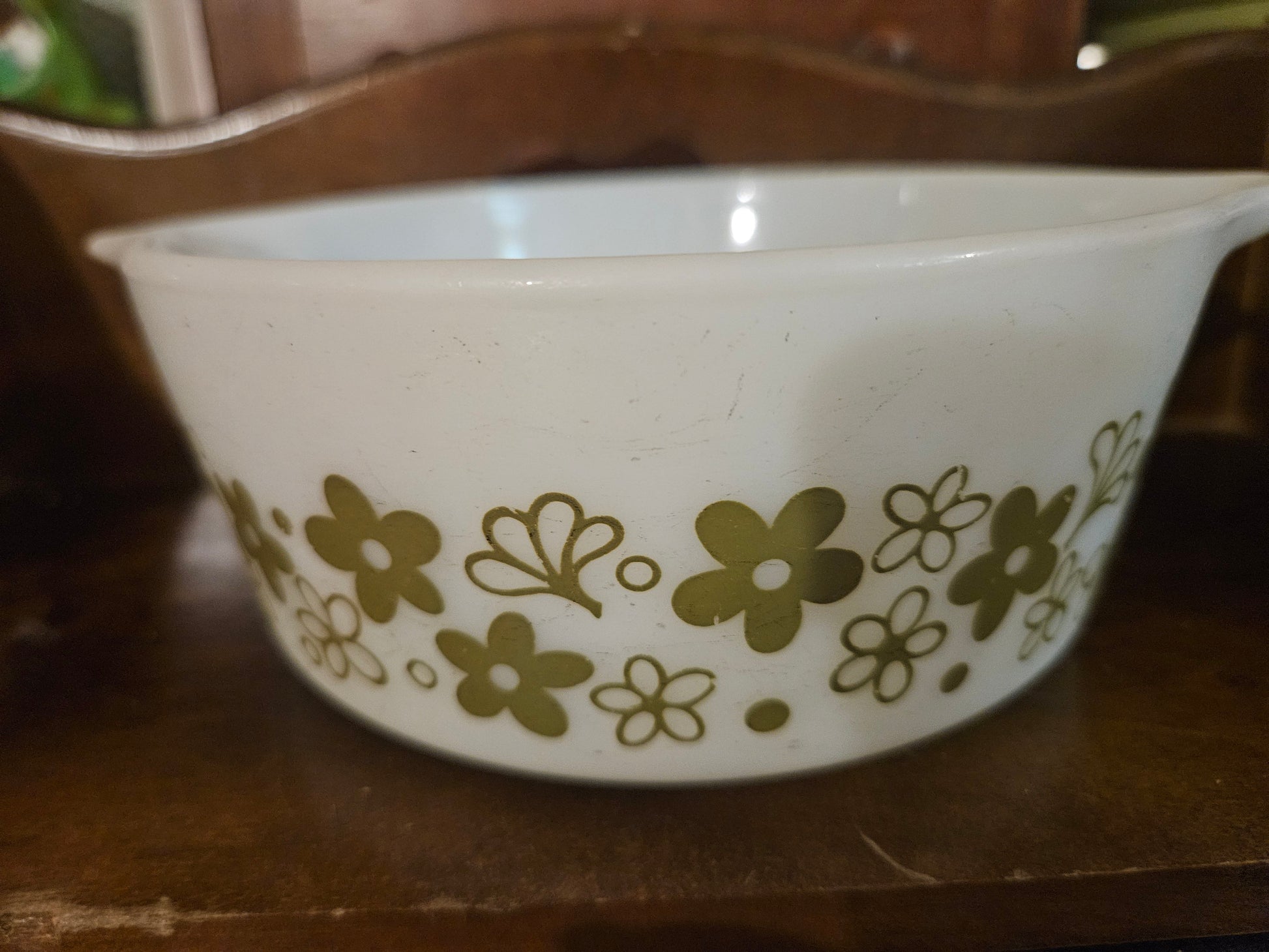 Vintage Pyrex Spring Blossom Green Crazy Daisy 472 casserole dish side view showing olive green daisy and butterfly pattern