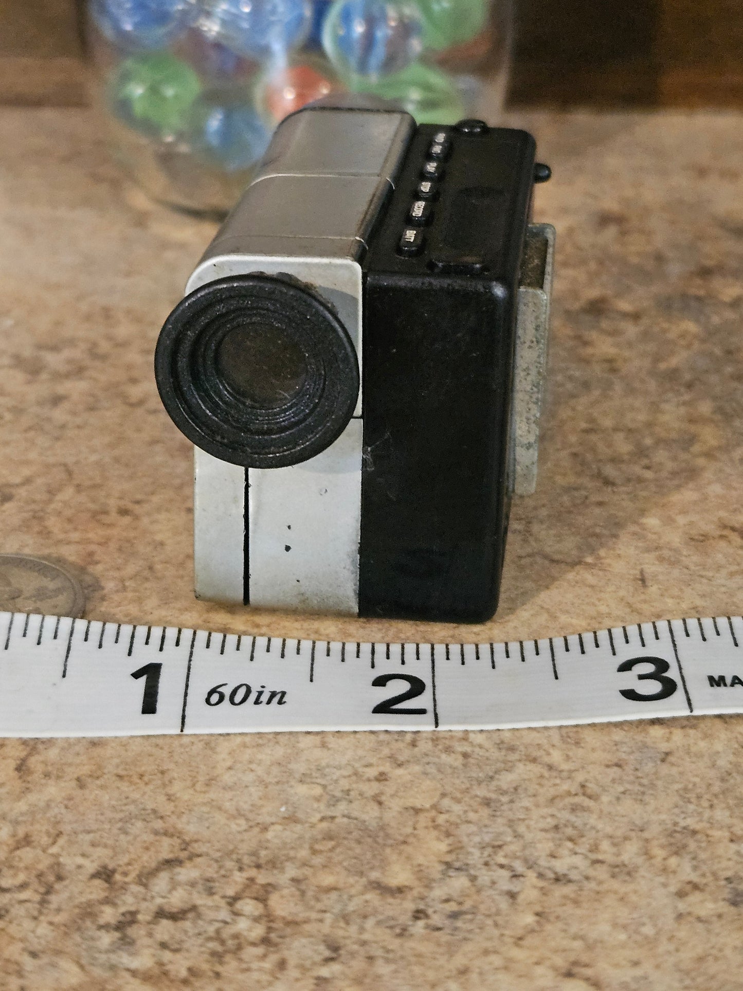 Front lens view of ACME miniature camcorder showing lens and button panel