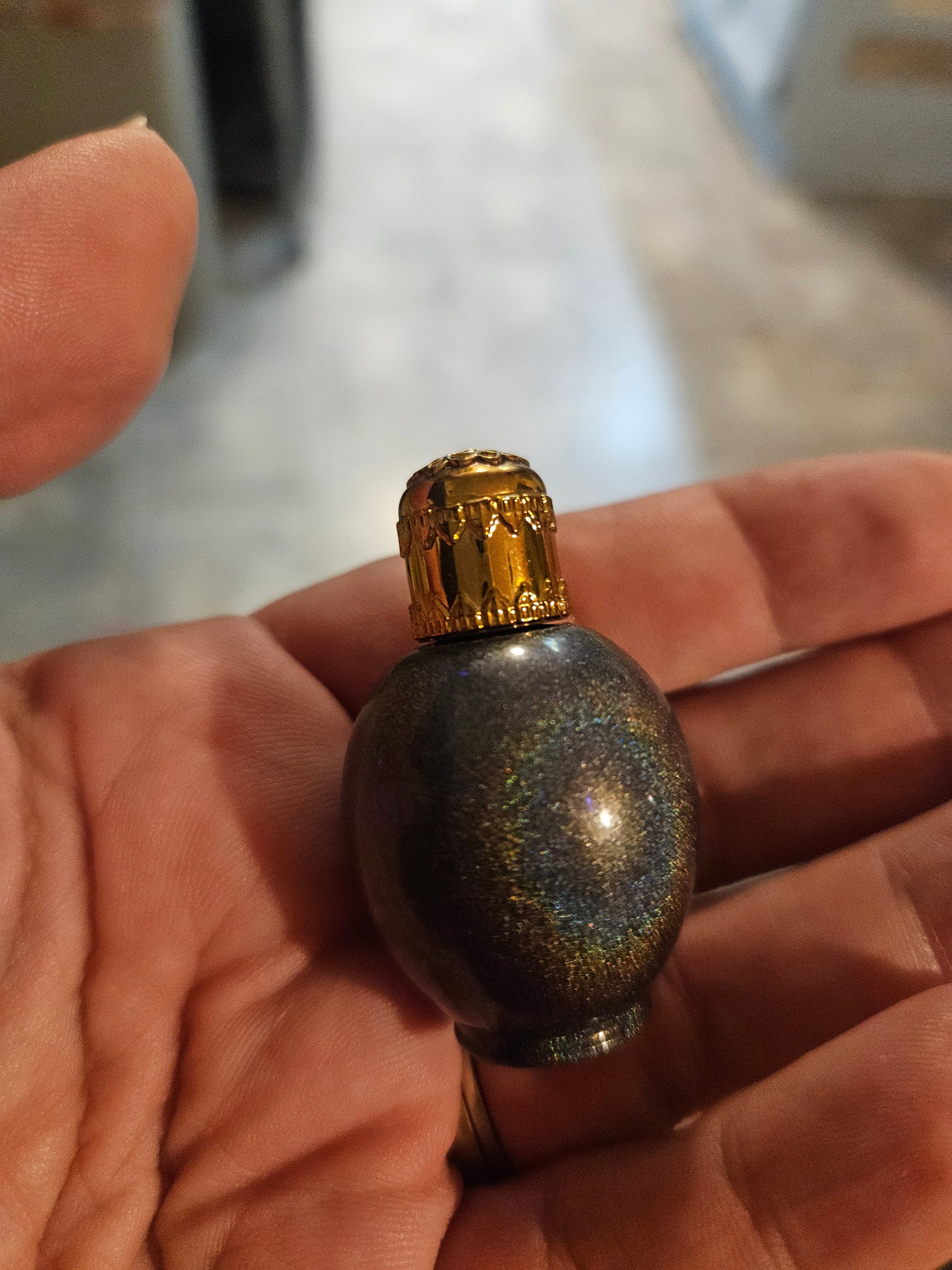 Miniature Lampe Berger galaxy glitter fragrance bottle with ornate gold filigree cap