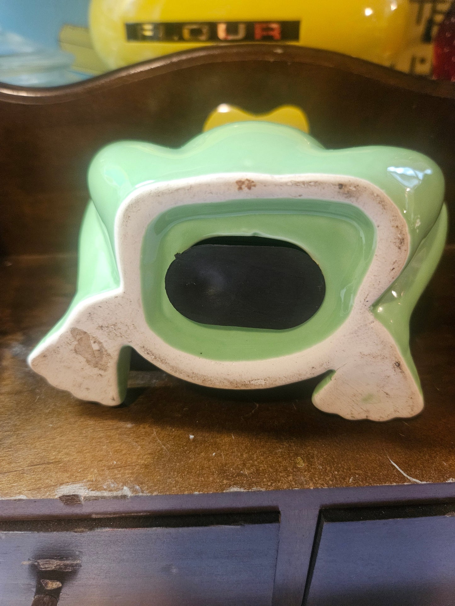 Bottom view showing open base and chips on unglazed rim
