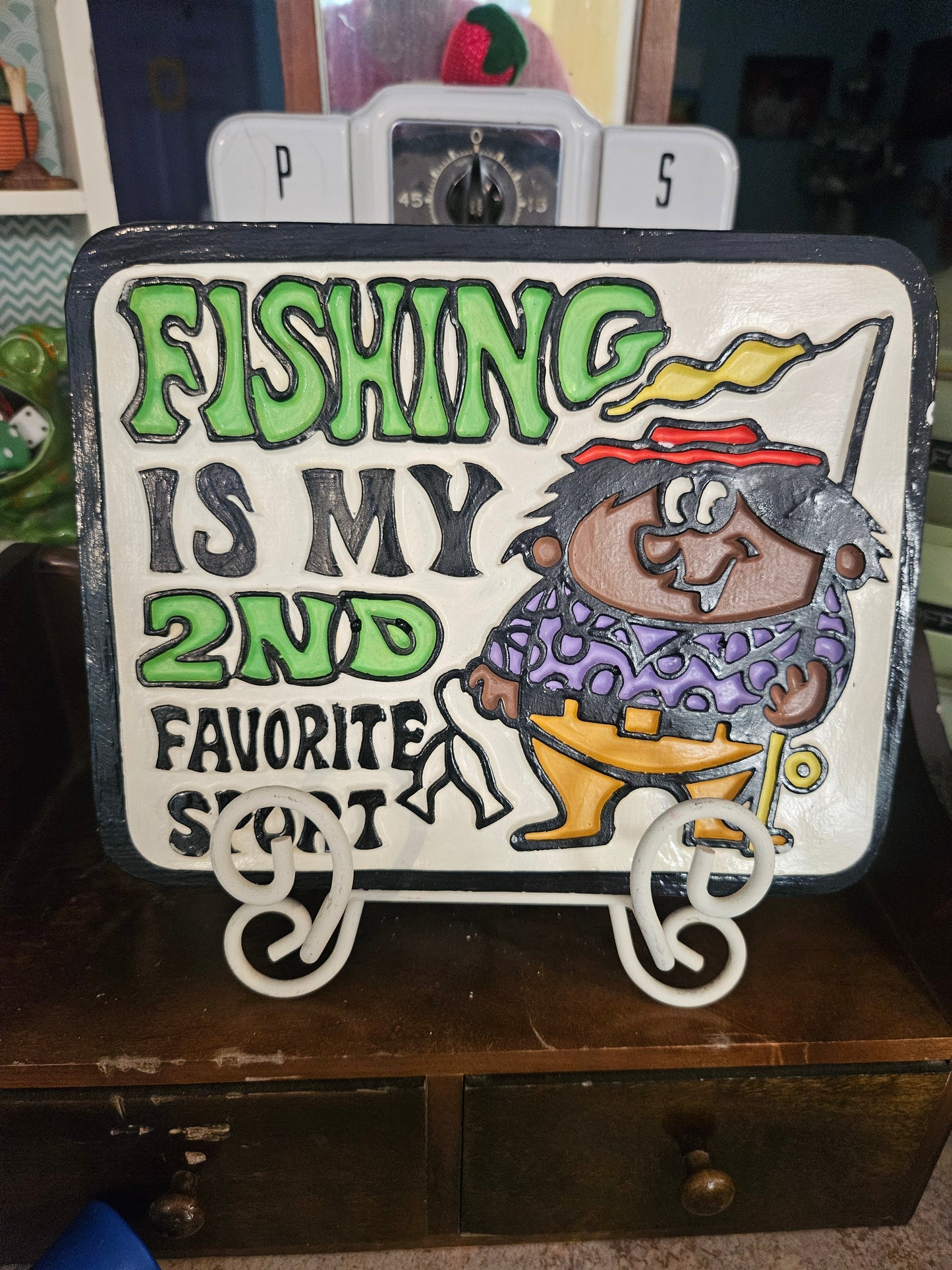Front of vintage ceramic wall plaque reading Fishing Is My 2nd Favorite Sport with cartoon fisherman character