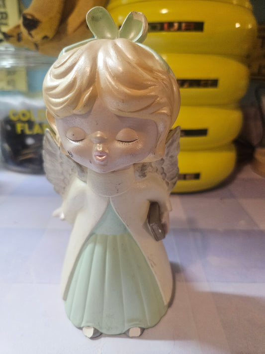 Vintage 1979 praying angel girl figurine front view showing mint green dress and closed eyes