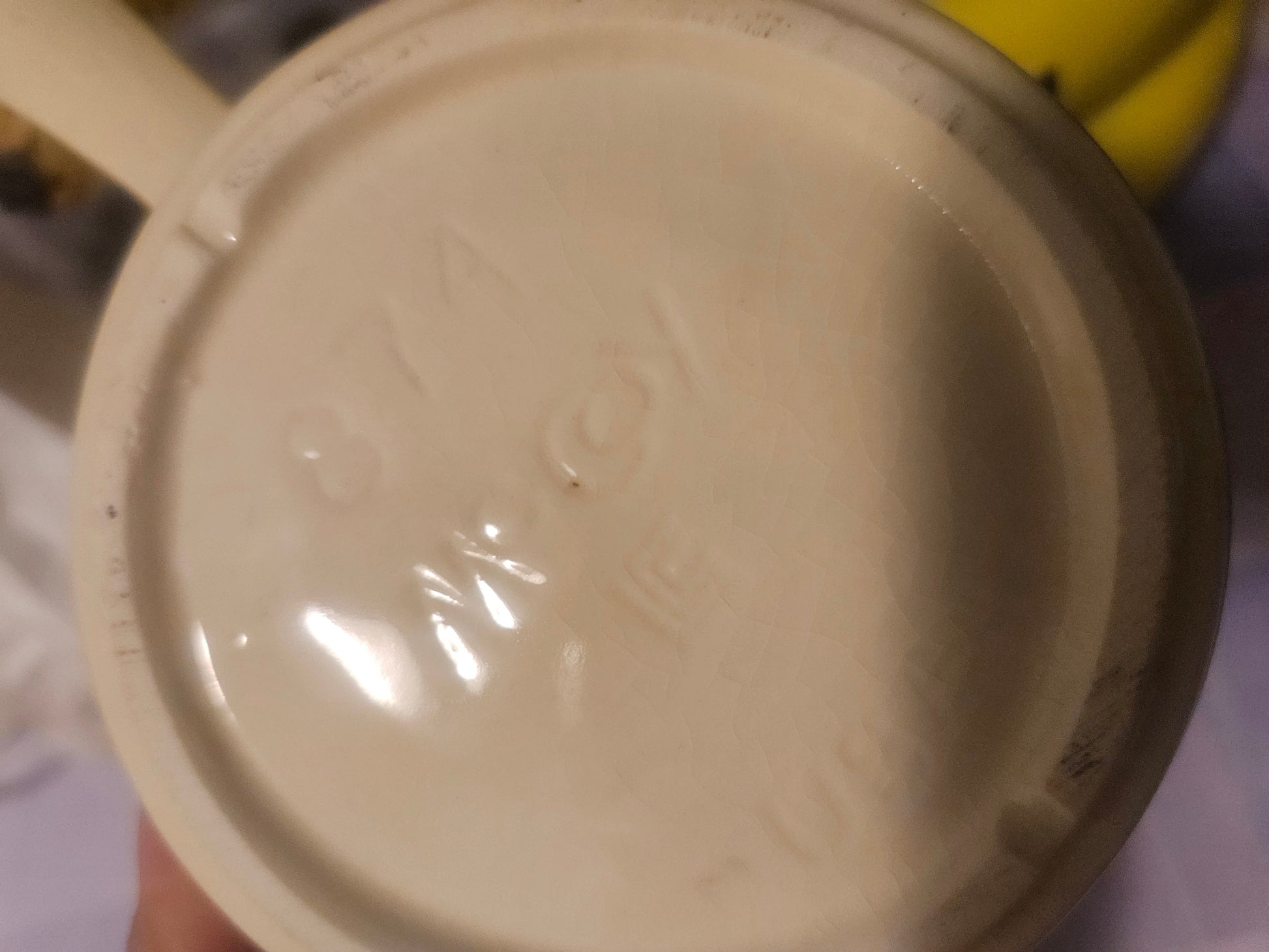 Base of vintage ceramic handled bowl showing embossed maker's mark