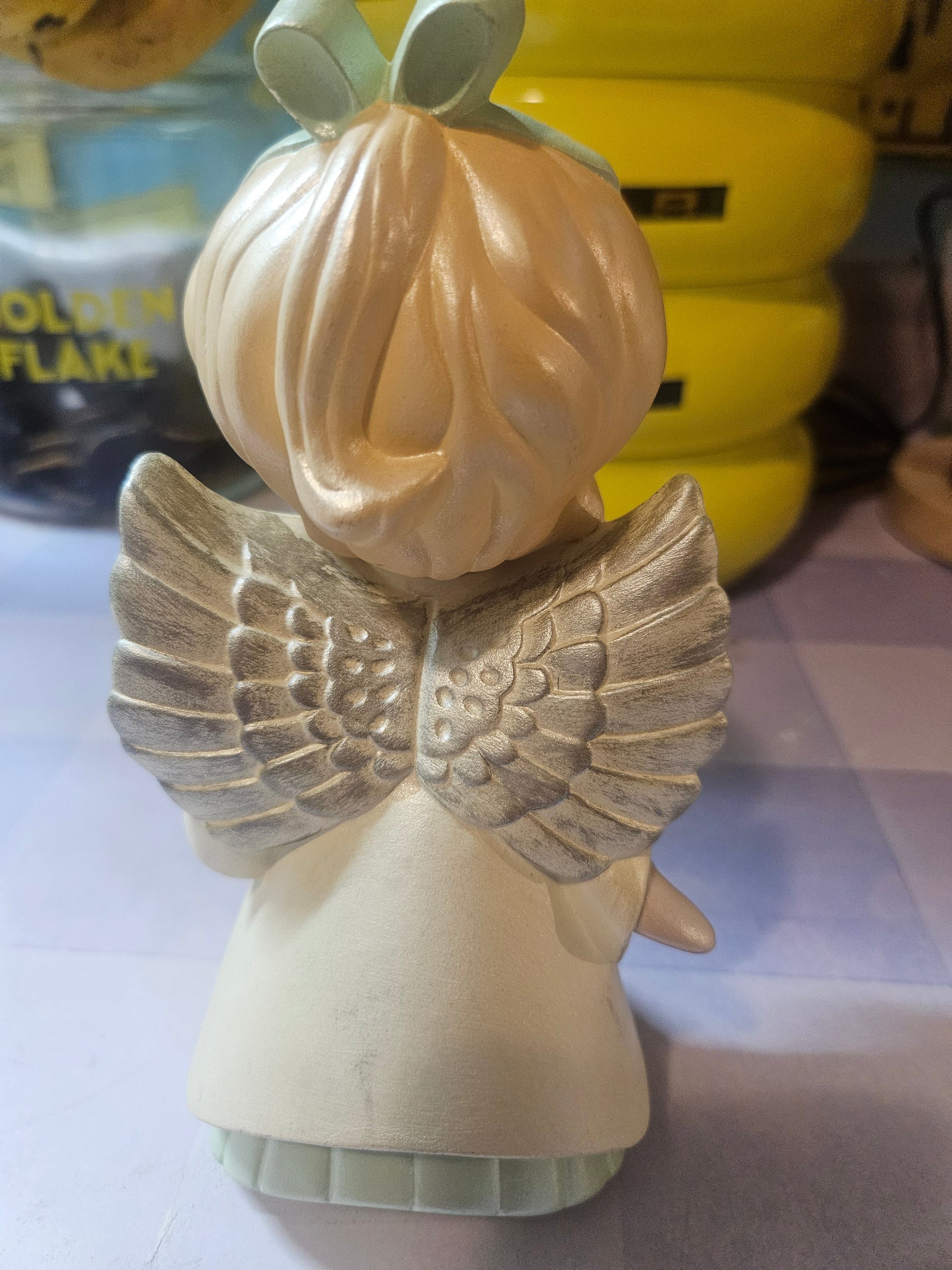 Back view showing full gold and silver sculpted wings