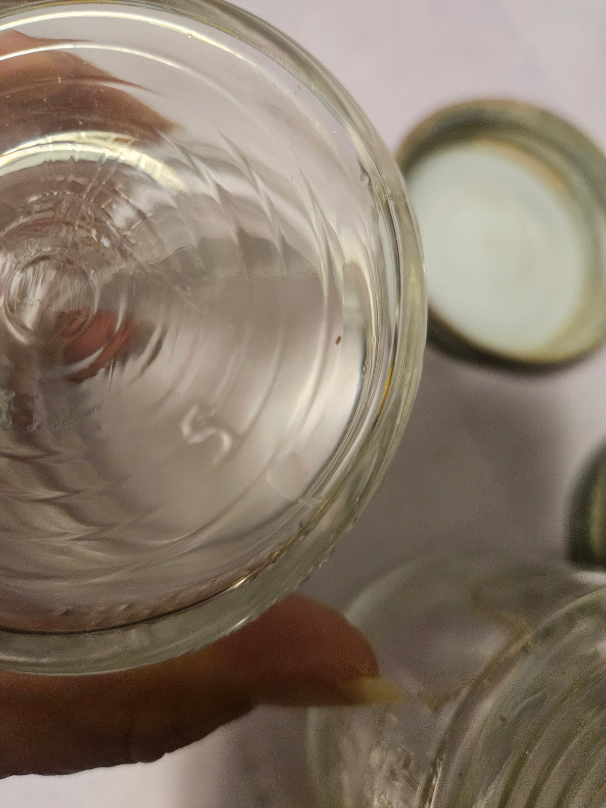 Overhead view of two Ball jars and the inside of their zinc lids with seals