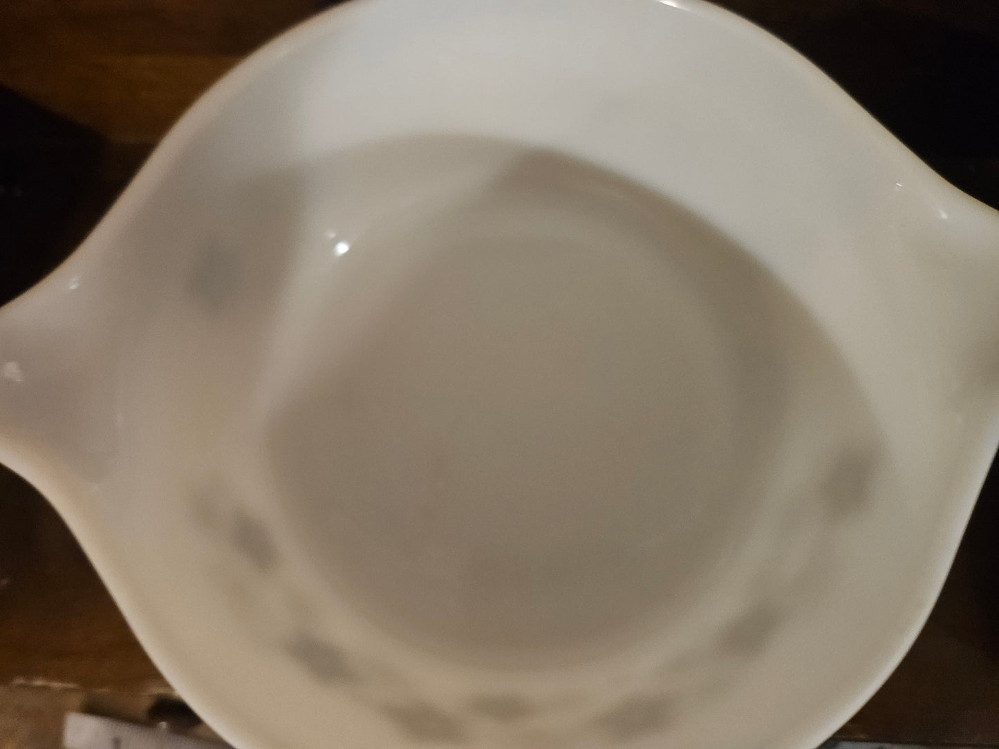 Interior of Pyrex Spring Blossom 472 casserole dish showing utensil marks and light staining