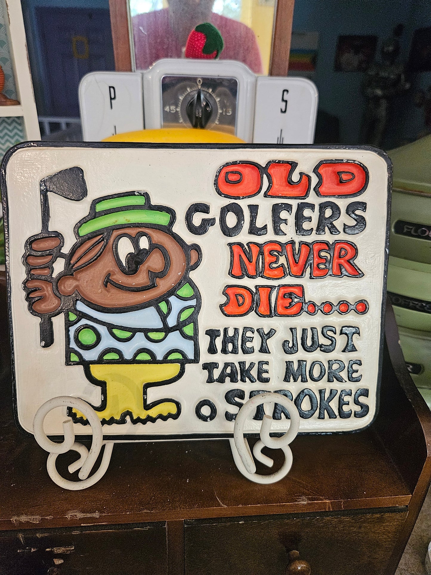 Front of vintage ceramic wall plaque reading Old Golfers Never Die They Just Take More Strokes with cartoon golfer