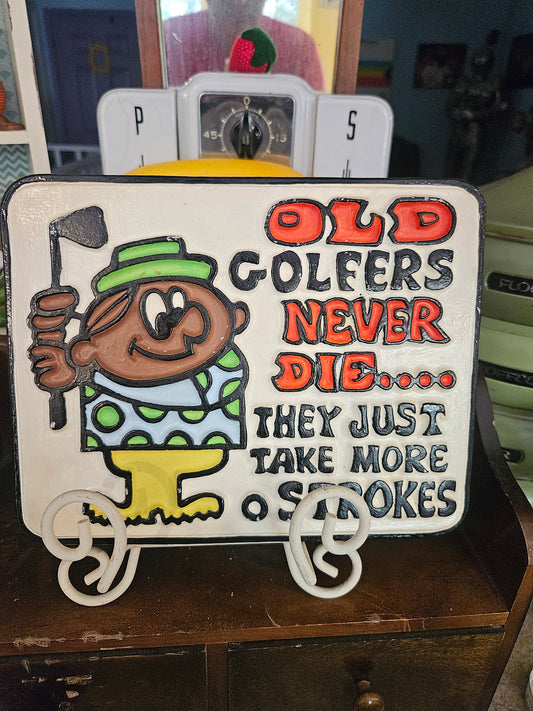 Front of vintage ceramic wall plaque reading Old Golfers Never Die They Just Take More Strokes with cartoon golfer