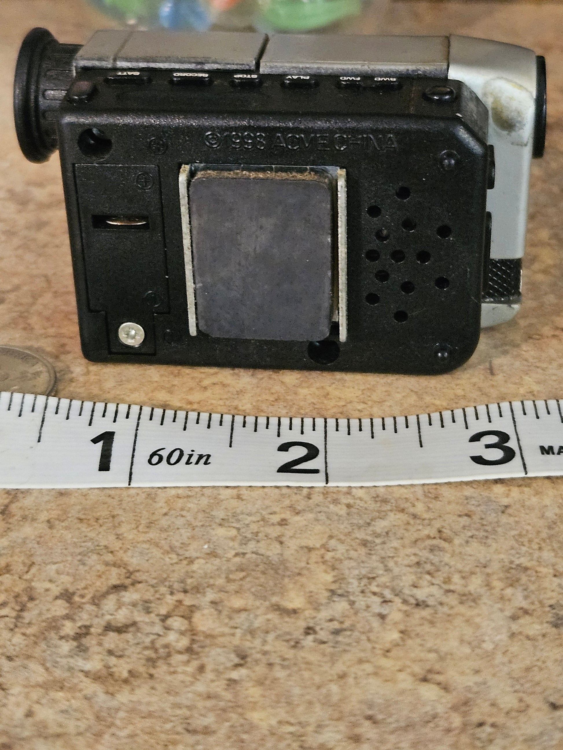 Back of ACME miniature camcorder showing 1993 ACVEC-INA copyright stamp and battery compartment