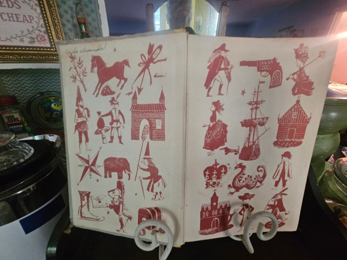 Bambi book open showing red and white illustrated endpapers with storybook characters
