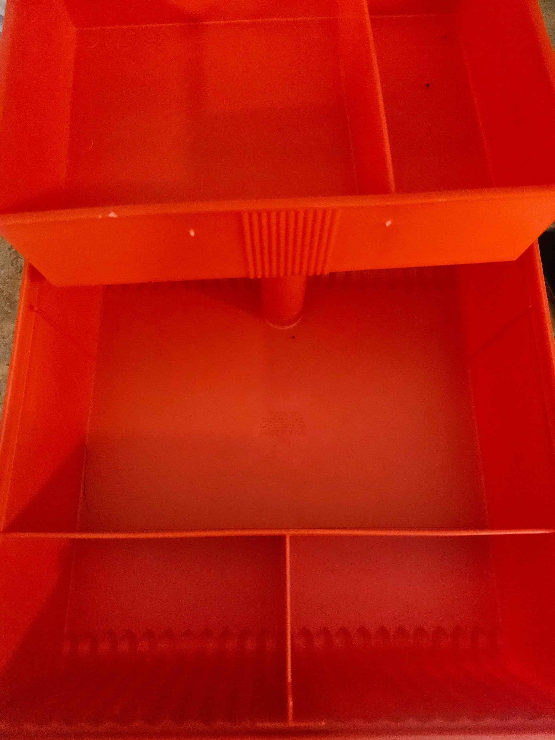 Interior of Sassaby case showing two-tier divided compartments and lower well