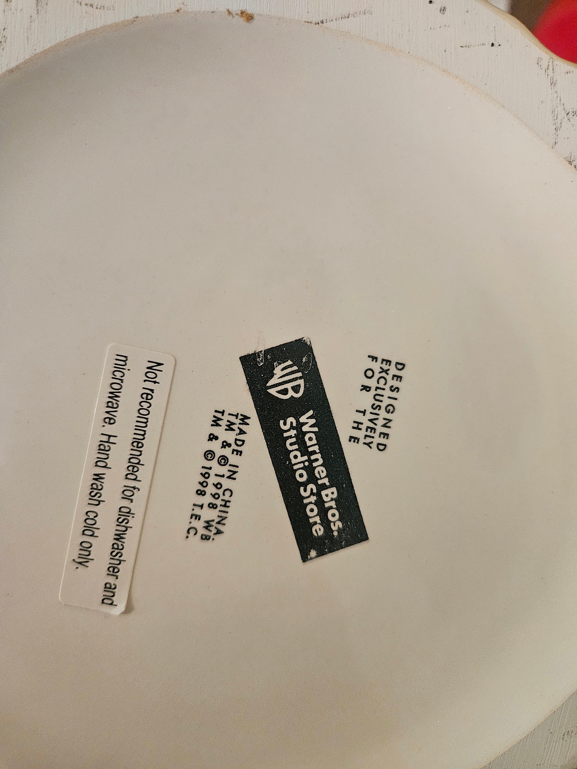 Bottom of Glinda teapot showing Warner Bros Studio Store 1998 Turner Entertainment license mark and hand wash care label
