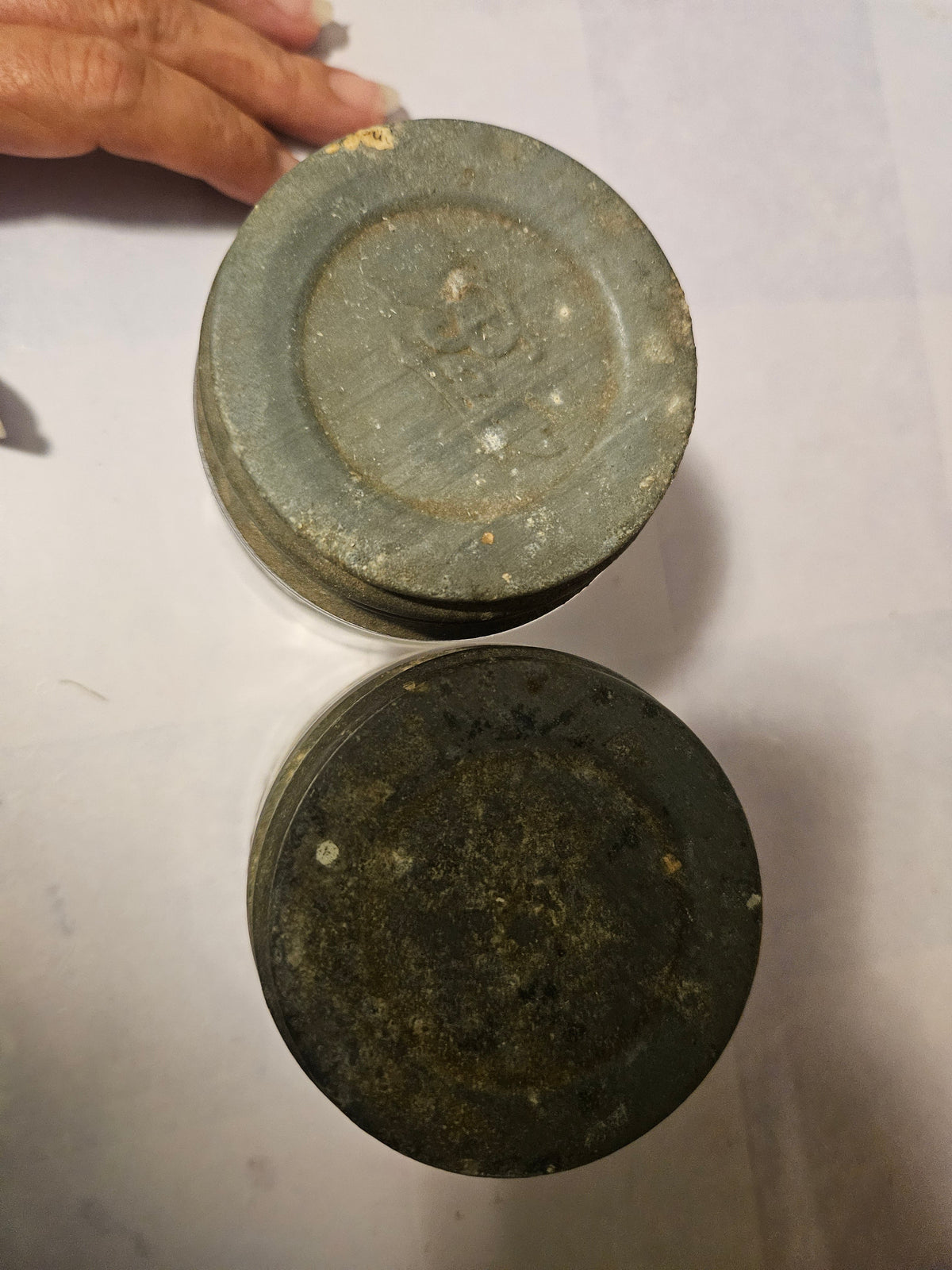 Overhead view into both glass jars with two zinc lids alongside
