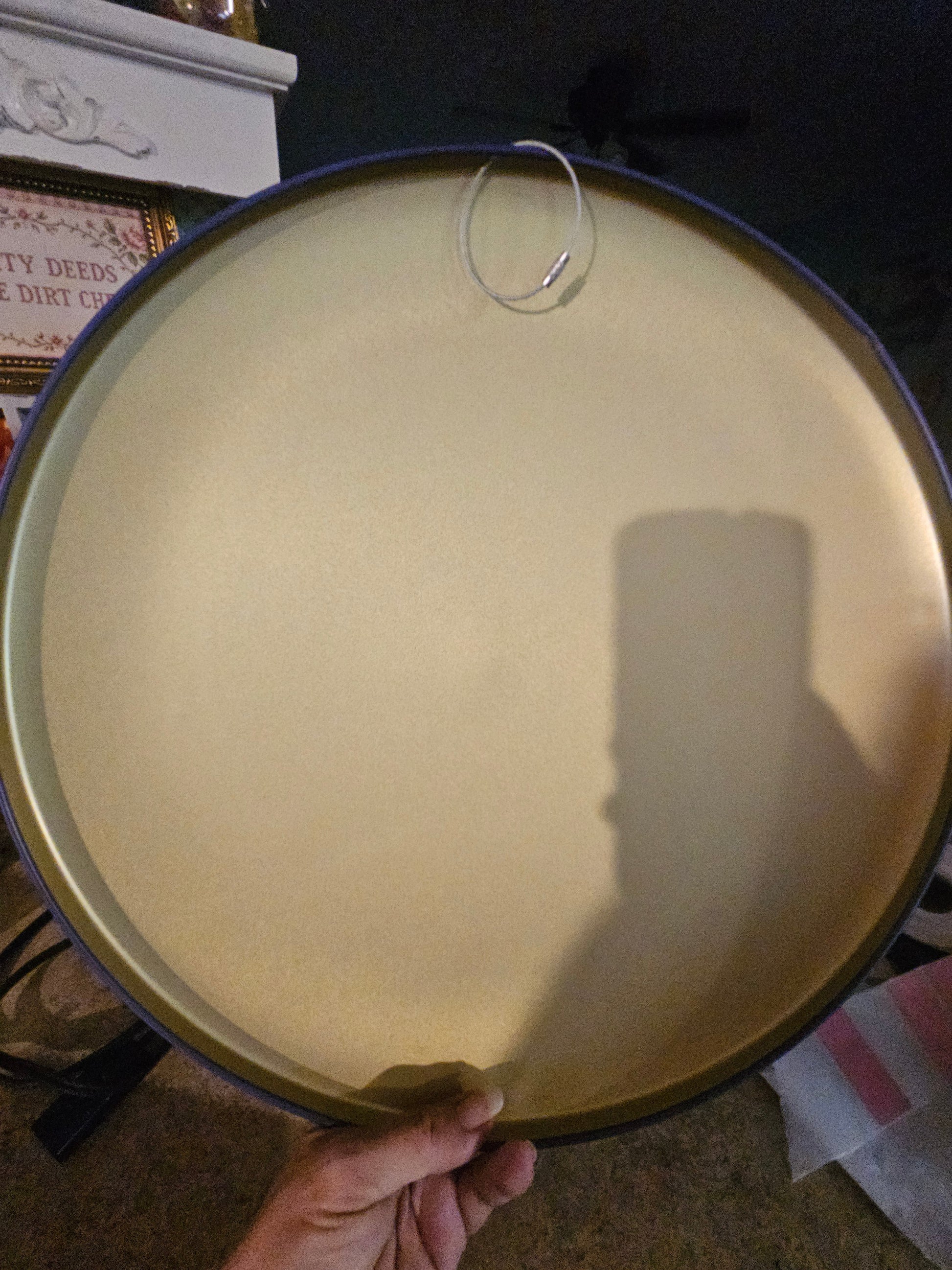 Back of Moon Pie round metal sign showing wire hanger loop and gold metal back