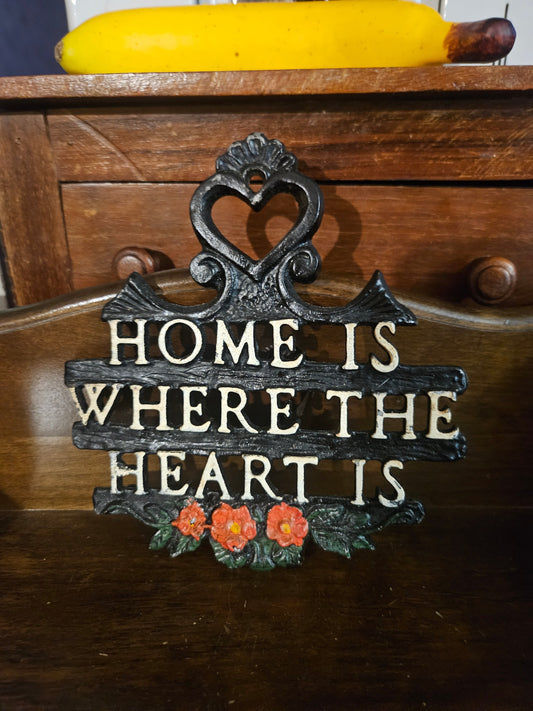 Vintage cast iron Home Is Where the Heart Is wall plaque showing orange roses and heart scroll hanger, front view