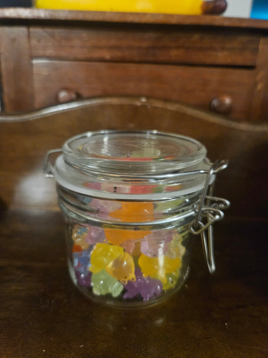 Swing-top glass jar filled with colorful translucent resin animal figurines
