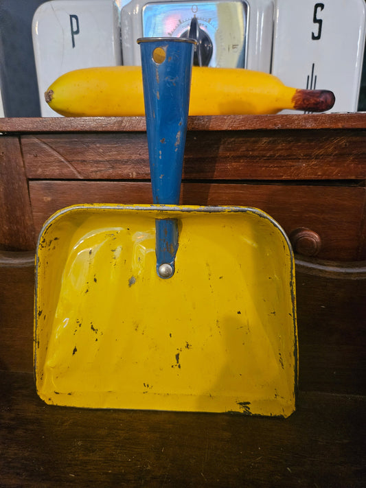 Vintage mini tin dustpan front view showing yellow interior and cobalt blue handle with chippy paint
