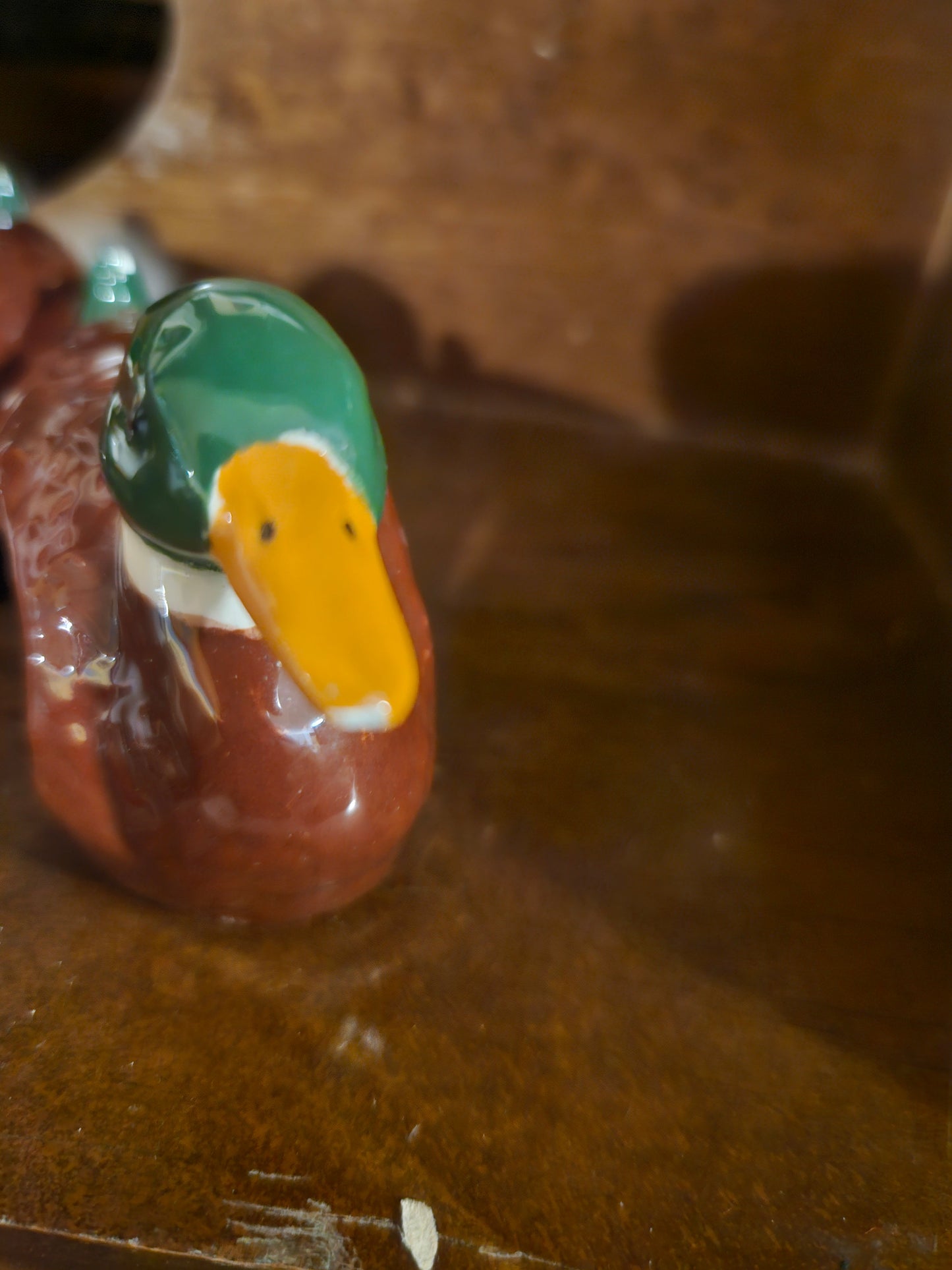 Close-up of mallard duck napkin ring showing green head and yellow beak detail