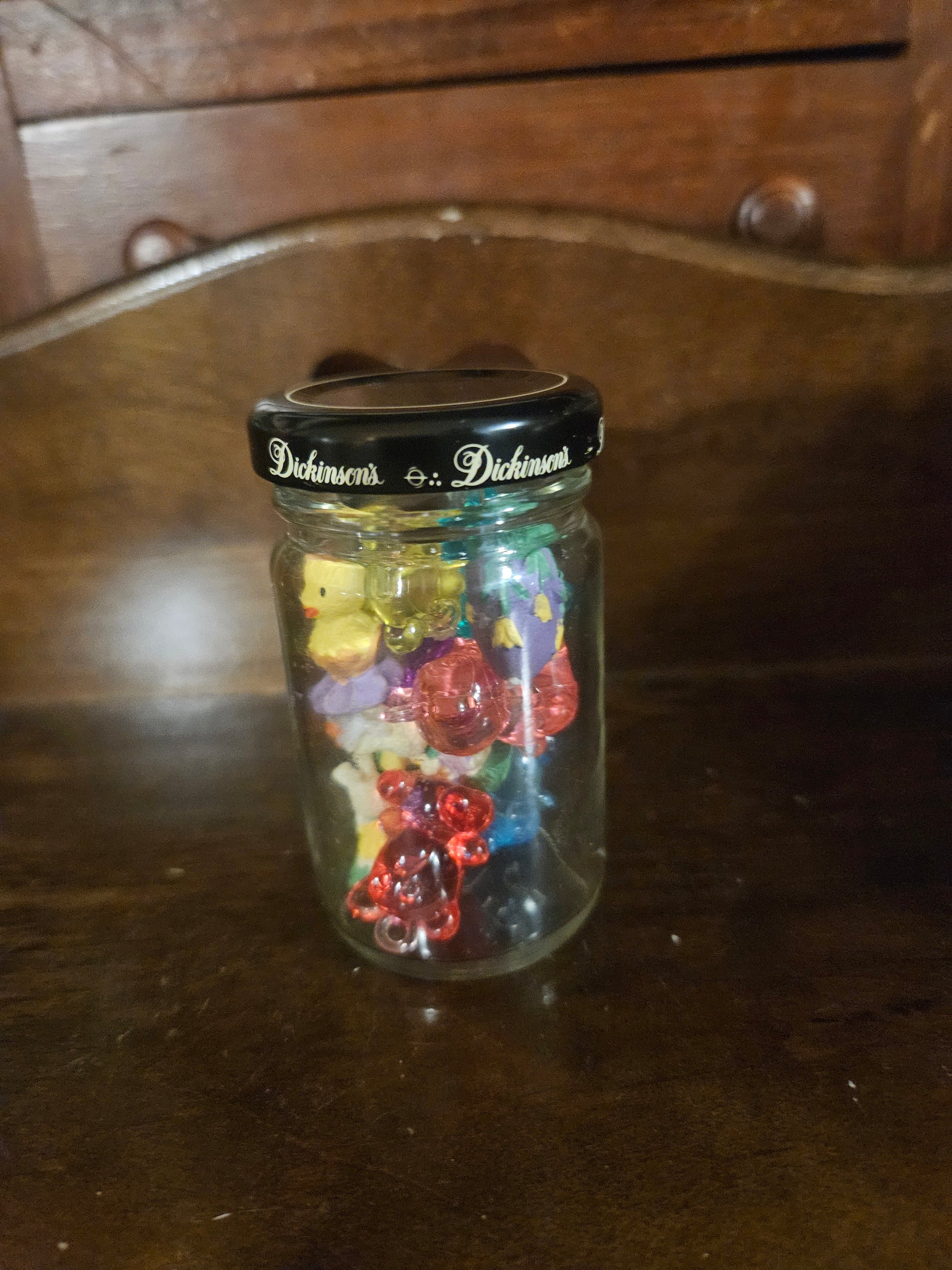 Dickinson's glass jar with black lid filled with colorful Easter mini figurines